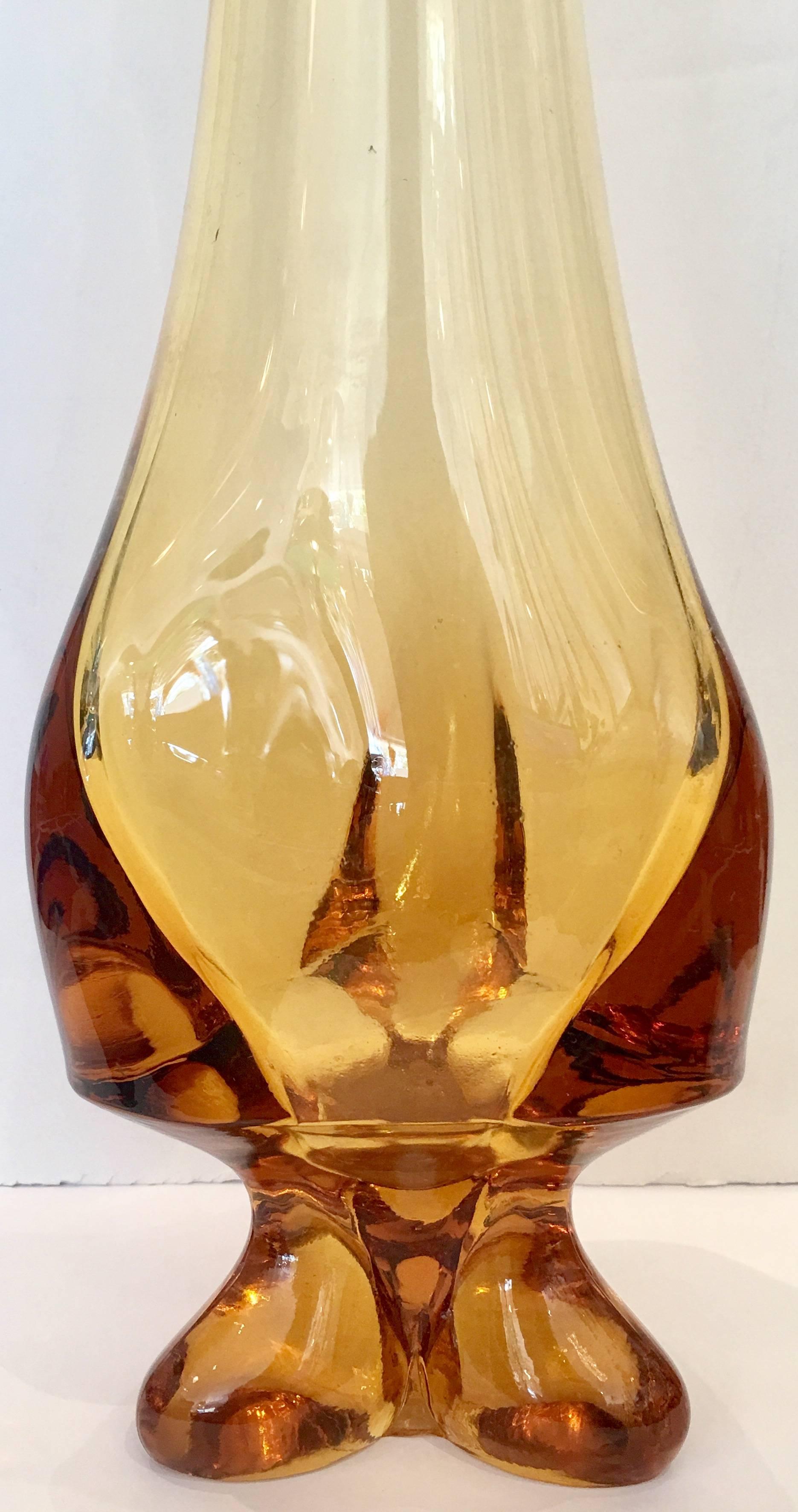 A rare three point footed amber stretch art glass vase by Viking Glass company. The underside shows the Viking pontil mark.