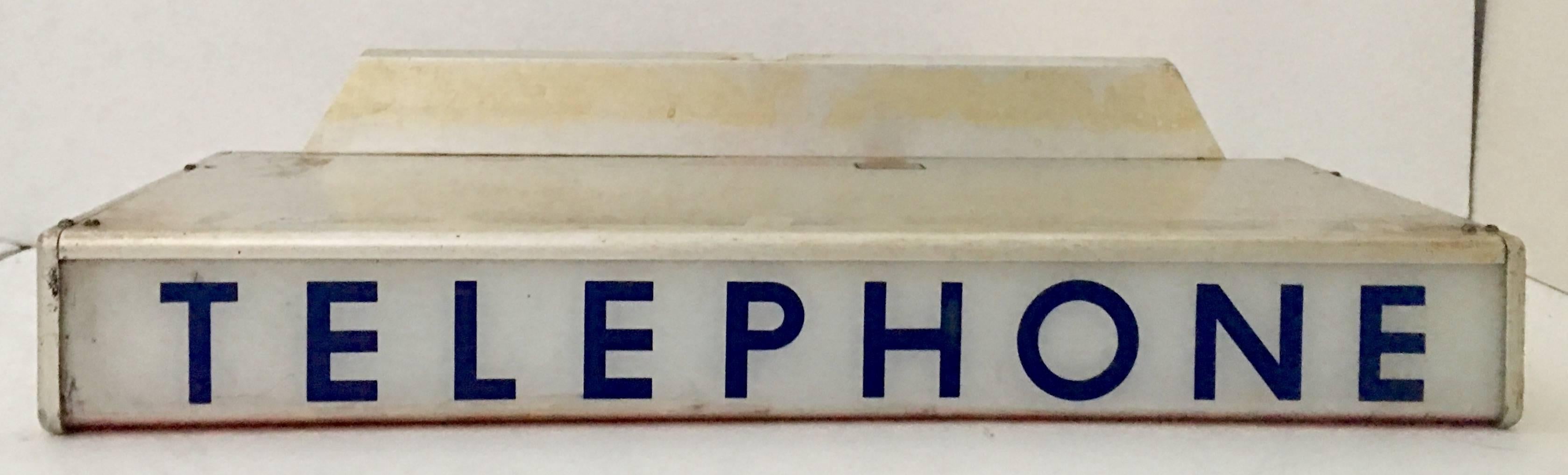 Extremely cool and rare vintage, electrified stainless steel and plastic/resin telephone booth light box sign insert. Manufactured by, Geeco Inc. of Kansas in 1932 for the Western Electric company. The sign is reverse printed on plastic. The sign is