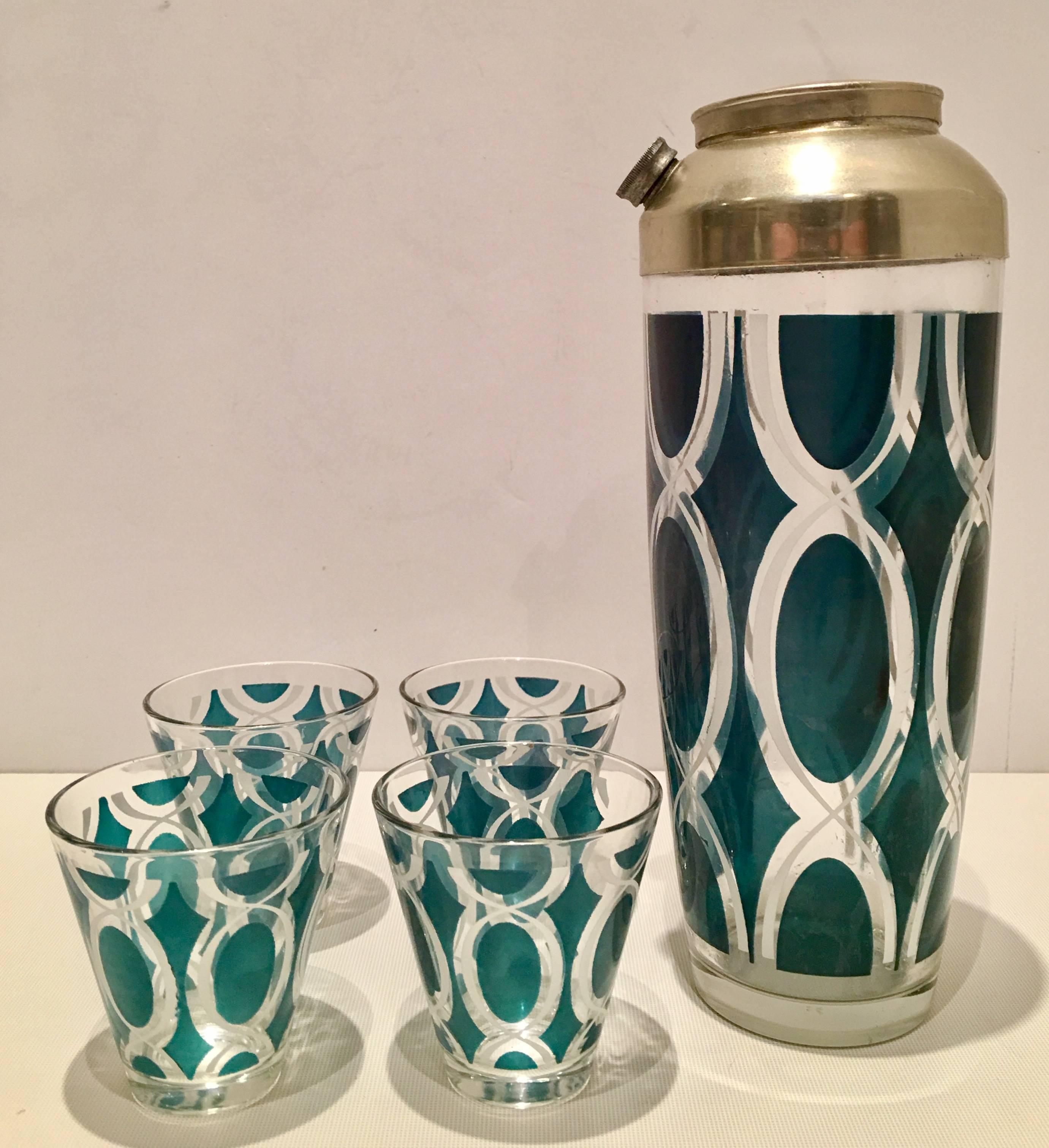Mid-Century Bohemia glass seven piece drinks set. Features a emerald green and white geometric design. Includes four cocktail glasses and one three-piece cocktail shaker with silver plate two-piece top.
Cocktail glass measures, 3" H x