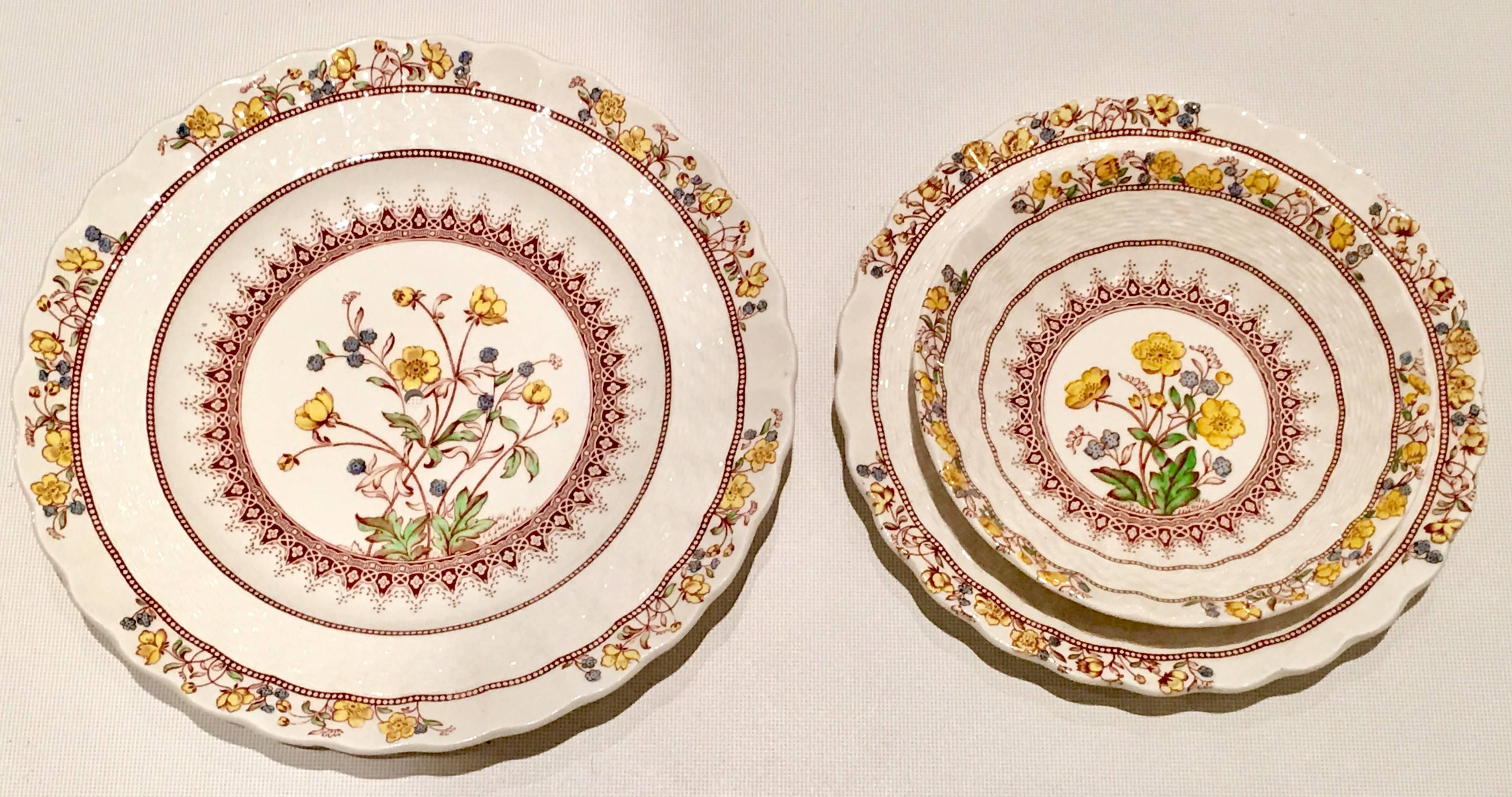 English earthenware eleven piece dinnerware set in, "Buttercup" by Copeland Spode.
Pattern features, a fluted and scallop with basket weave detail edge, on a white ground with yellow, iris, green flowers and brown decor. Each piece