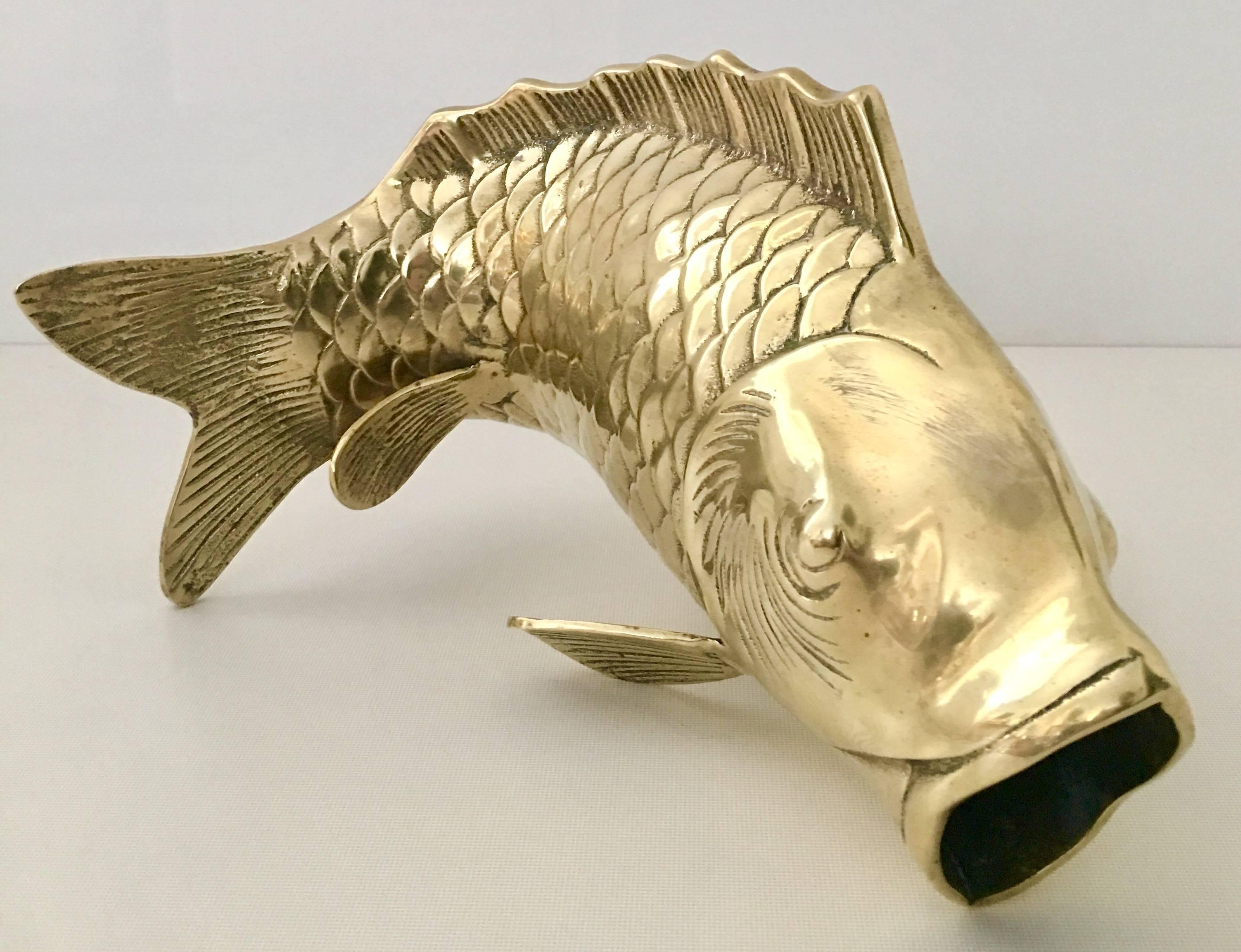 Incredible lifesize Koi fish vase sculpture made of solid brass. Features life like scale and fins and open mouth vase detail. Can be displayed in several positions.