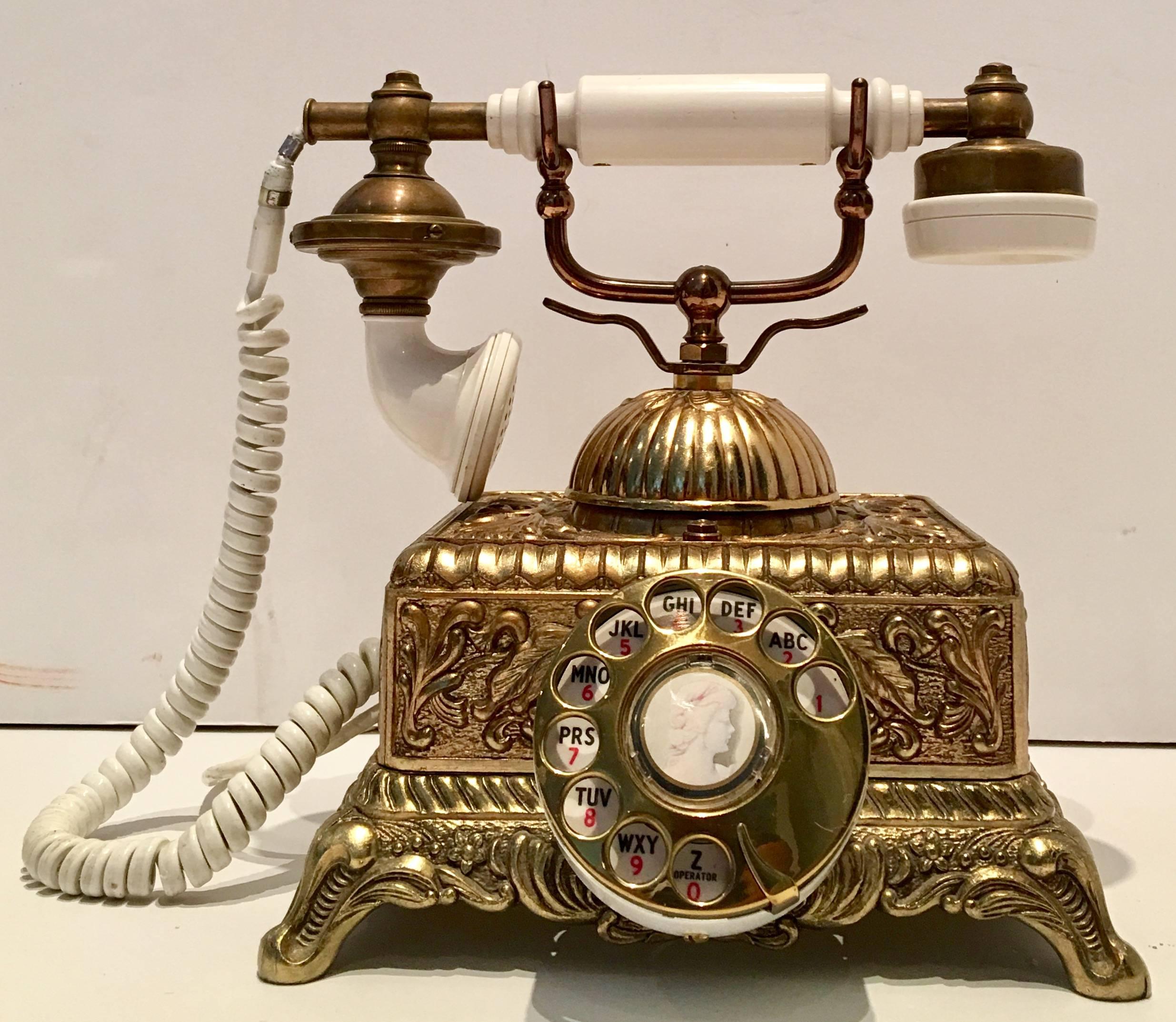 Vintage Illinois Bell Telephone French style cameo rotary reposse telephone. Features a gilt reposse Art Nouveau style pattern with a figural bell at the top. Rotary dial has a photo image of a female right facing Victorian cameo. Fully operational