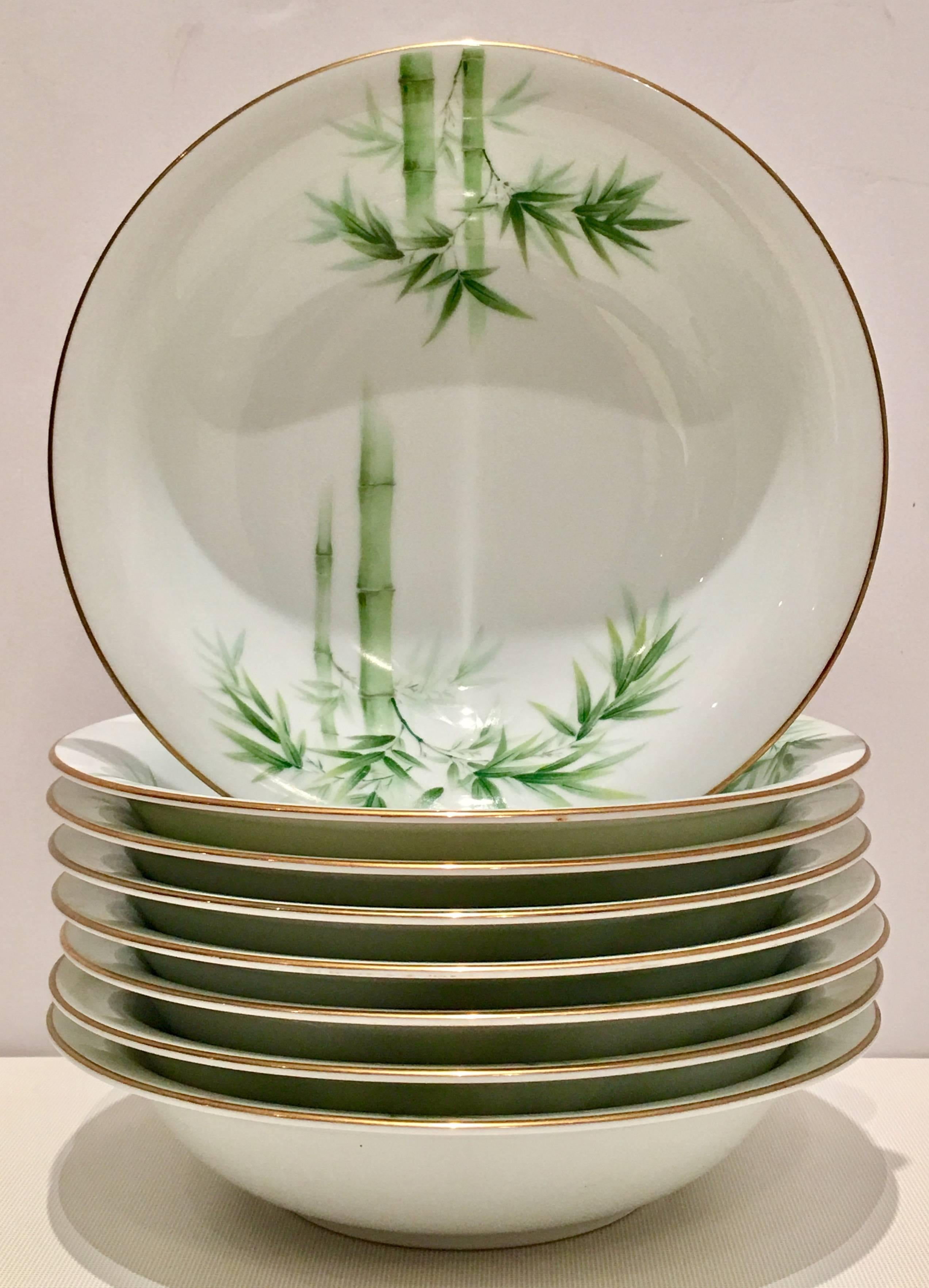 Vintage Japanese porcelain twenty - three-piece china set. This bright white ground pattern features a bright green bamboo pattern with a 22-karat gold rim detail. Set includes, six dinner plates, eight rim soup bowls, eight salad or dessert plates