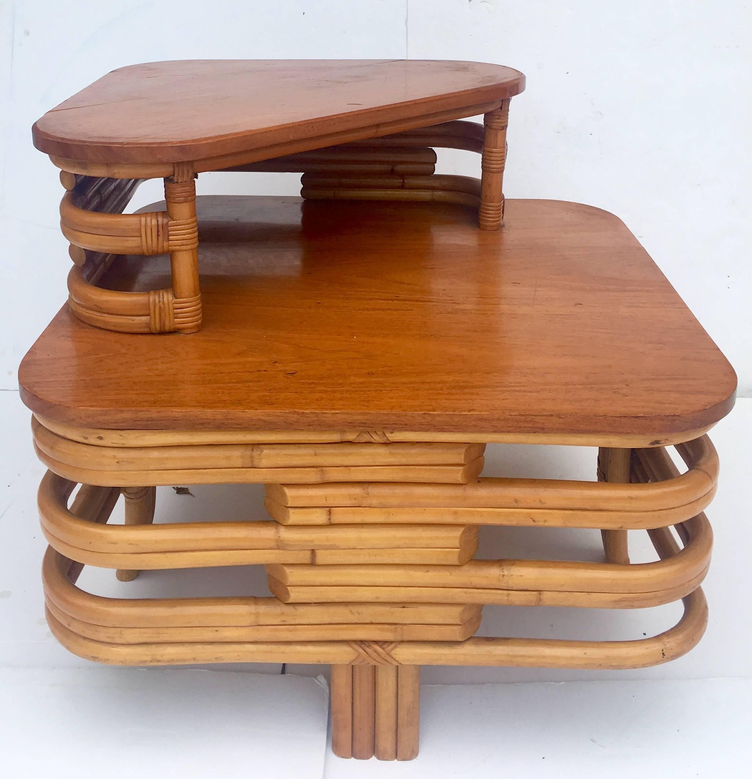 Art Deco Paul Frankl design RARE bent leg, rattan reed stack two-tier mahogany top table. This Art Deco slanted leg side or coffee table features mahogany stained tops and an open stacked reed design.
Dimensions:
Lower tier is 16