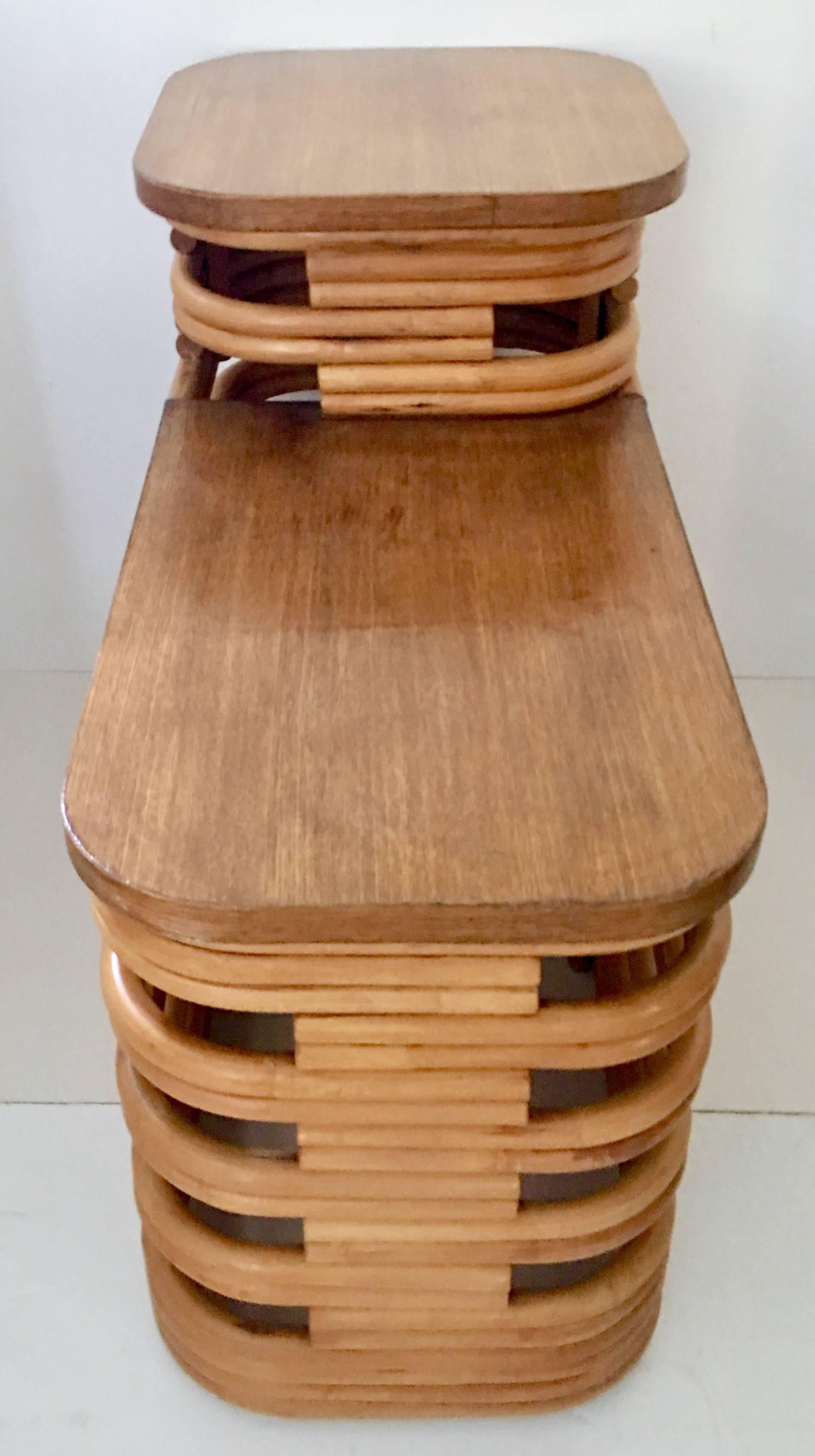 1940s Paul Frankl designed Art Deco style two-tier stacked rattan side table with stylized cut-out sides and beautiful mahogany tops on both tiers.