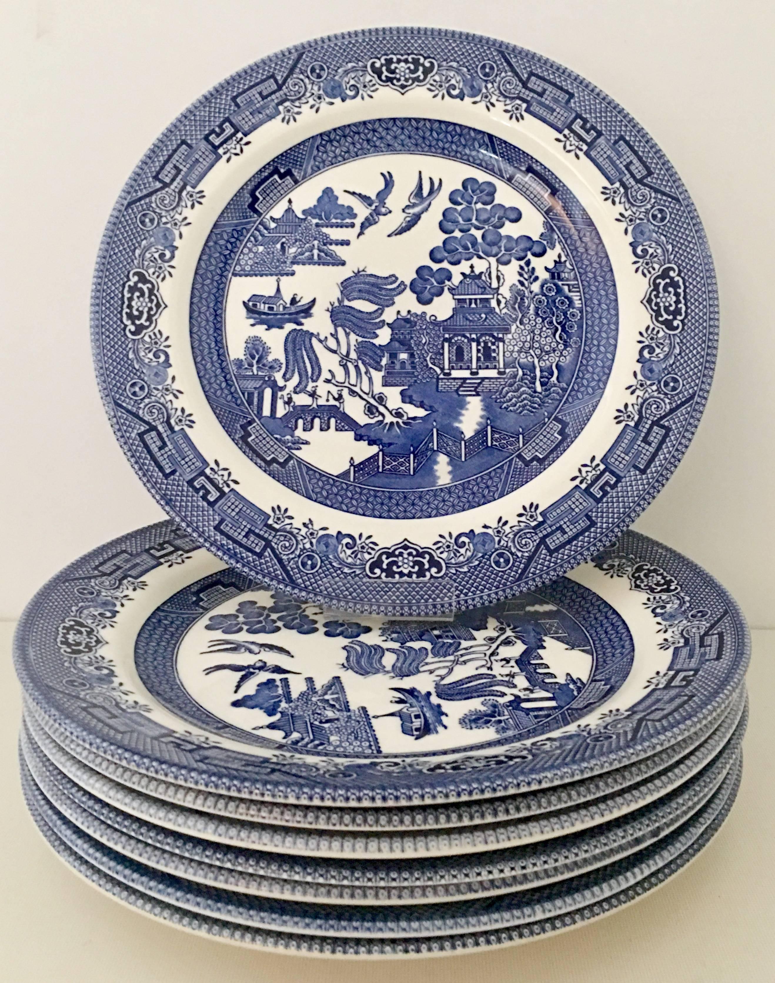 Vintage Staffordshire, England "Blue Willow" dinnerware, set of seventeen pieces. Set includes,
six dinner plates, six salad dessert plates, one divided oval serving platter, two large serving bowls and two small serving bowls. Each piece