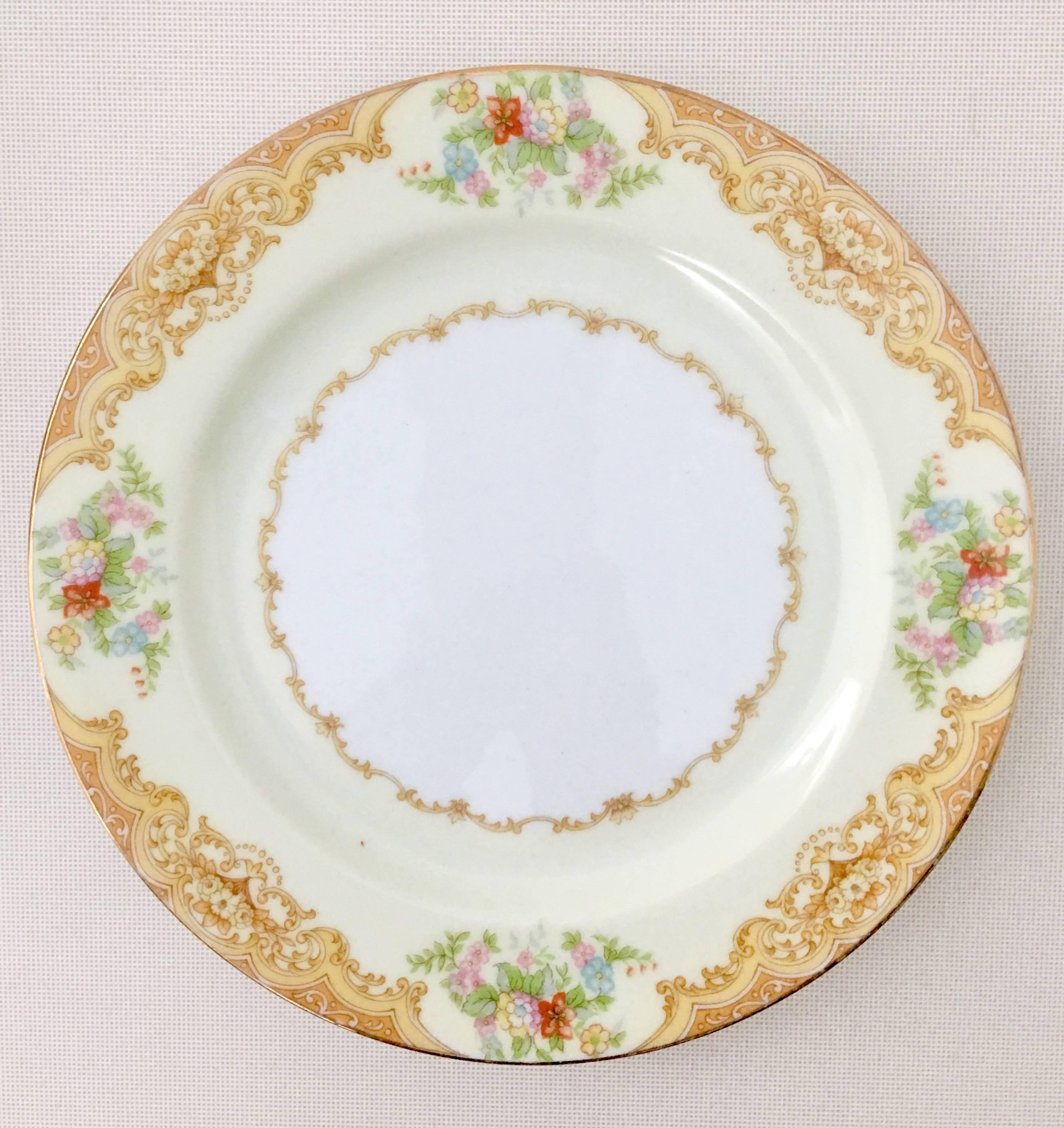 1930'S Art Nouveau hand-painted Japanese porcelain set of ten salad/dessert plates by, Noritake-Morimura Brothers. Pattern features a golden paisley and scroll rim pattern over a band of creamy yellow with a 22-karat gold edge detail. Each piece