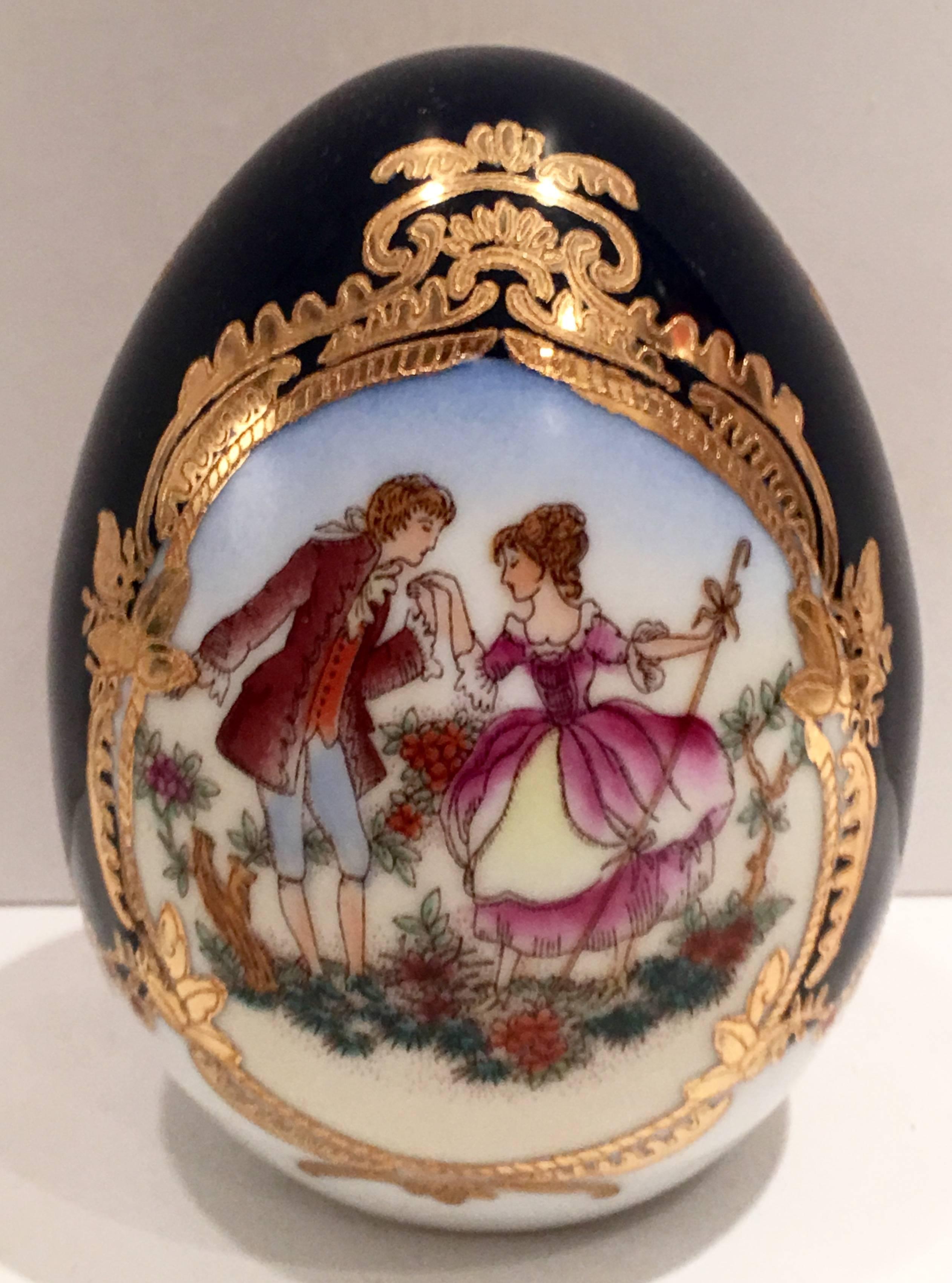 Mid-Century lovely cobalt and 22-karat gold detail double sided courting couple motif egg sculpture. Signed at the bottom in gold, L.F. Fine Porcelain Limoges-P.R.C.