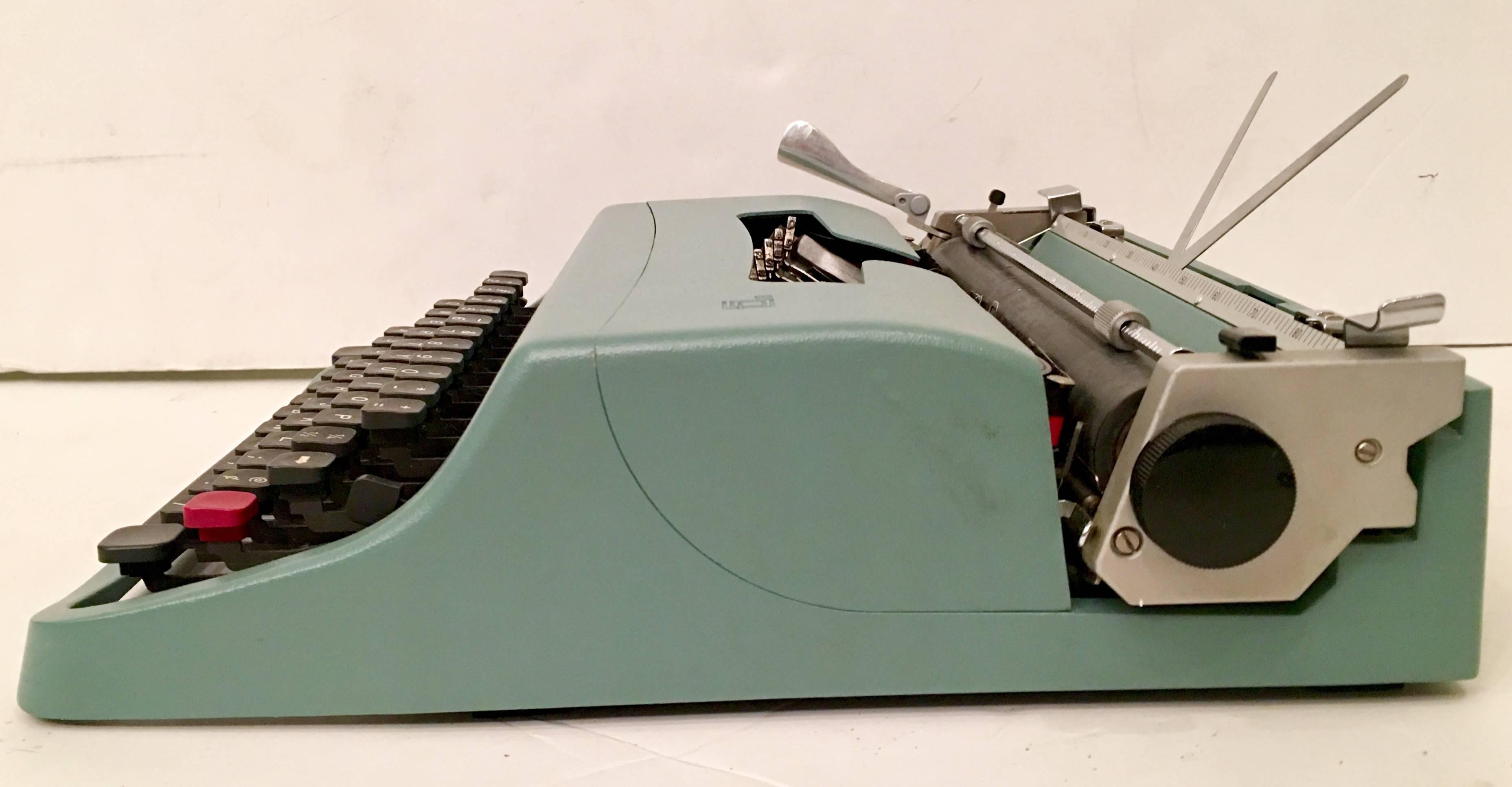 Fantastic 1960'S Olivetti Underwood "Lettera 32" green and chrome typewriter with original racing stripe case, two manuals and vinyl protective interior case. In working order and includes installed ribbon and excellent condition.
      