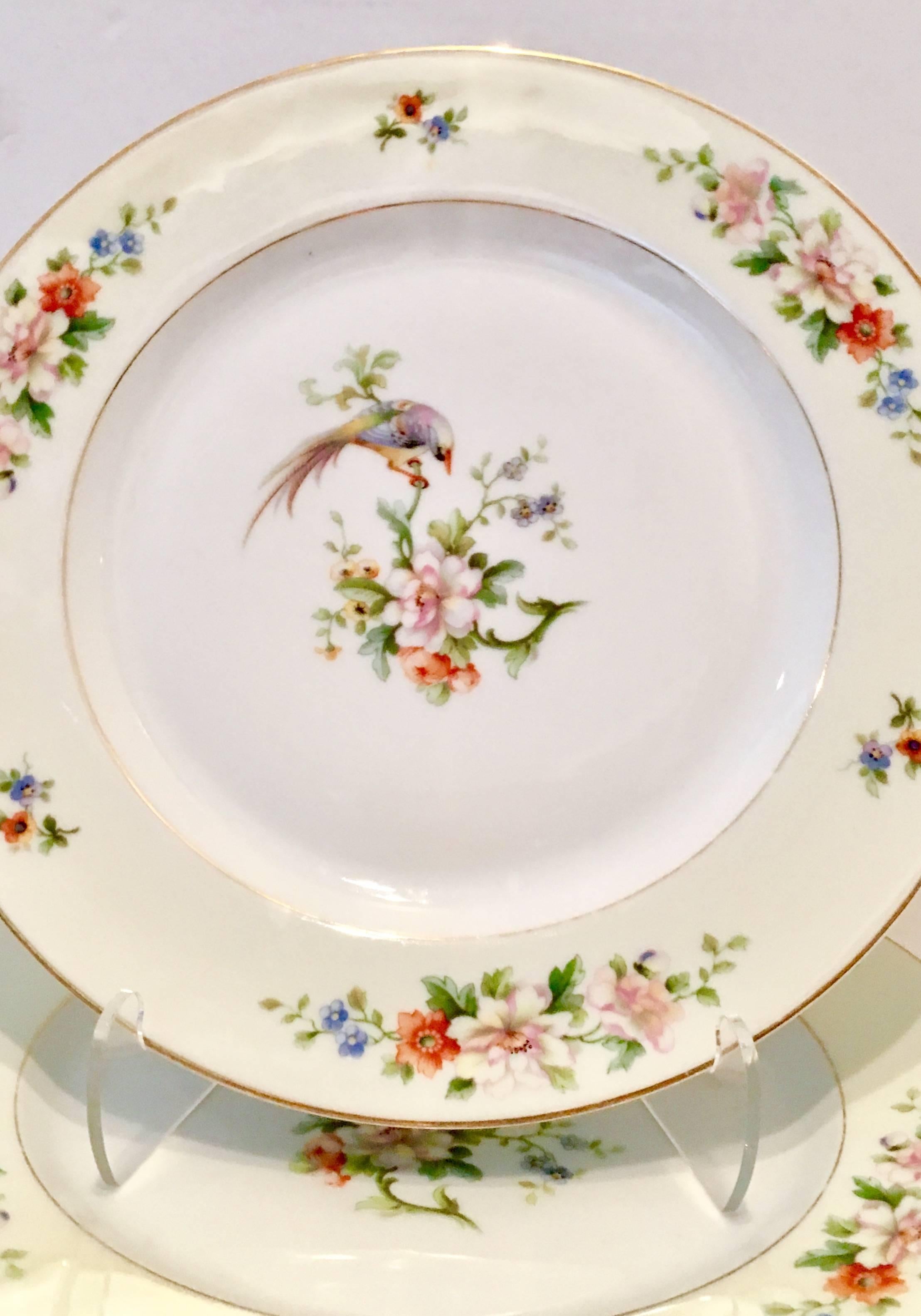 1920s set of eight porcelain hand-painted dinner plates, "Songbird" by, Heinrich & Co. - Bavaria.
The "Songbird" pattern features a bright white ground with pale yellow edge bird motif and a 22-karat gold rim and central