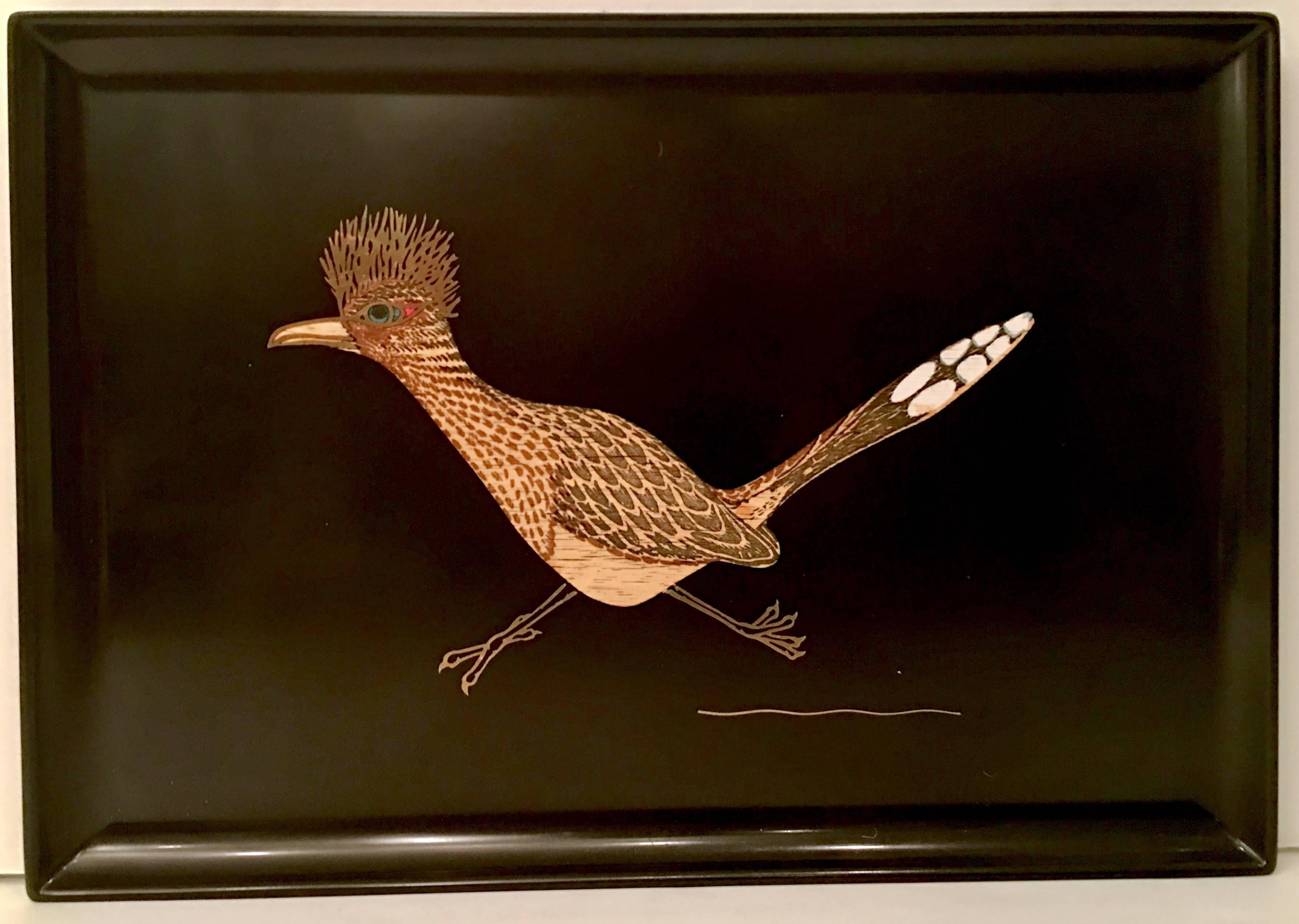 Midcentury rare and coveted hand inlaid "Road Runner" black lacquer tray by, Couroc of Monterey California. The original manufacturer tag is present on the underside.
 