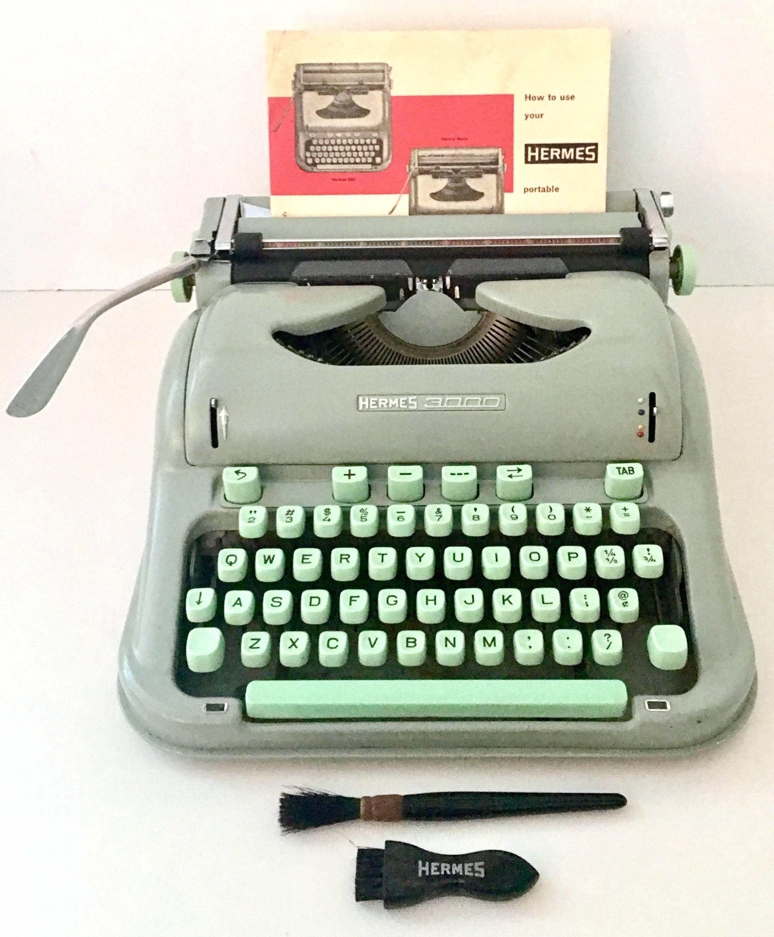 1950s Hermes 3000 mint green key portable typewriter made in Switzerland. The Hermes 3000, first introduced in 1958 and the first of several models to come, was innovative for its time. It was one of the first portable typewriters for "every
