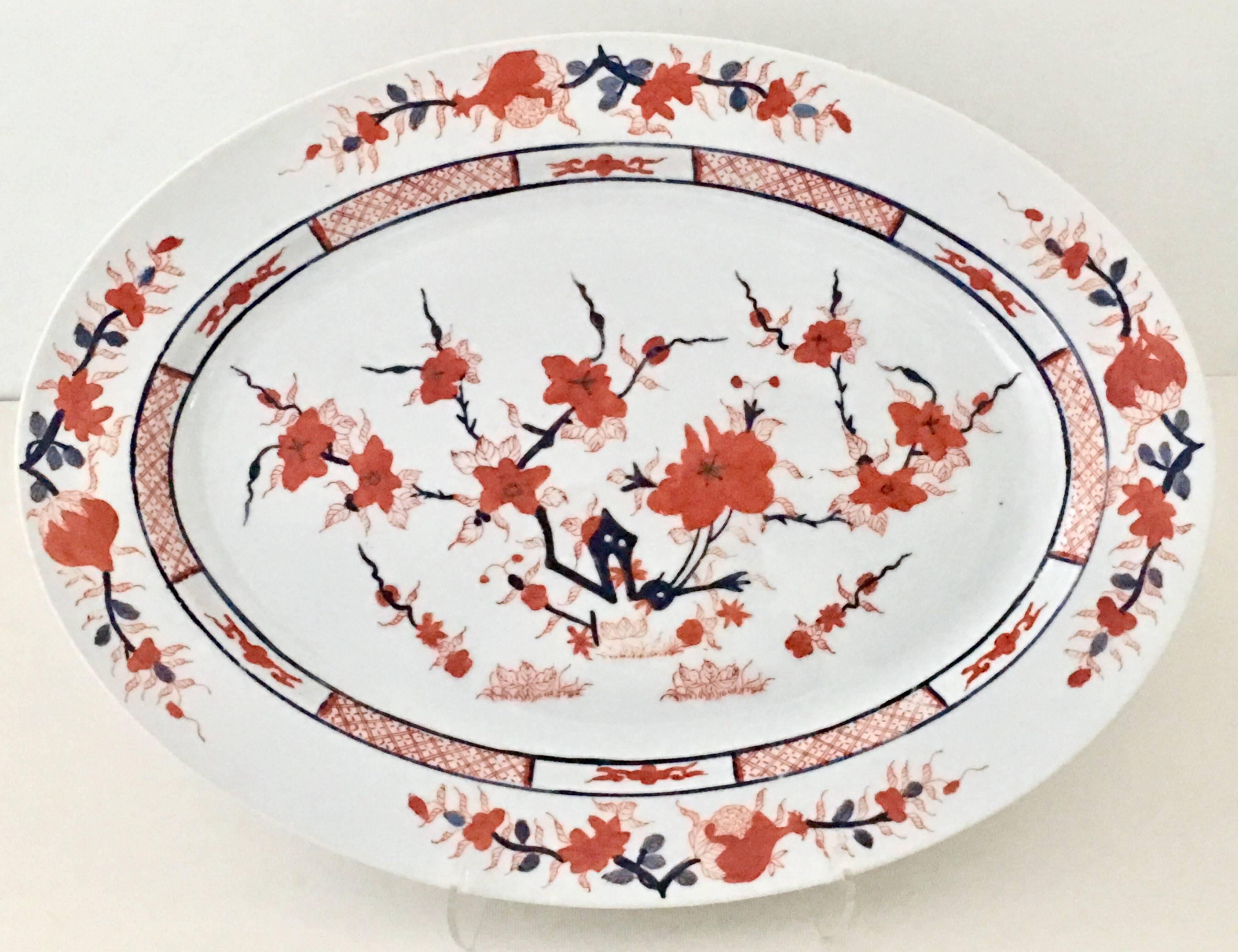 20th Century Japanese Imari porcelain decorated in Hong Kong set of two serving pieces.
Features a hand-painted white ground with 22-karat gold hand-painted and enameled ink blue and red to orange hues. Each piece is marked on the underside,