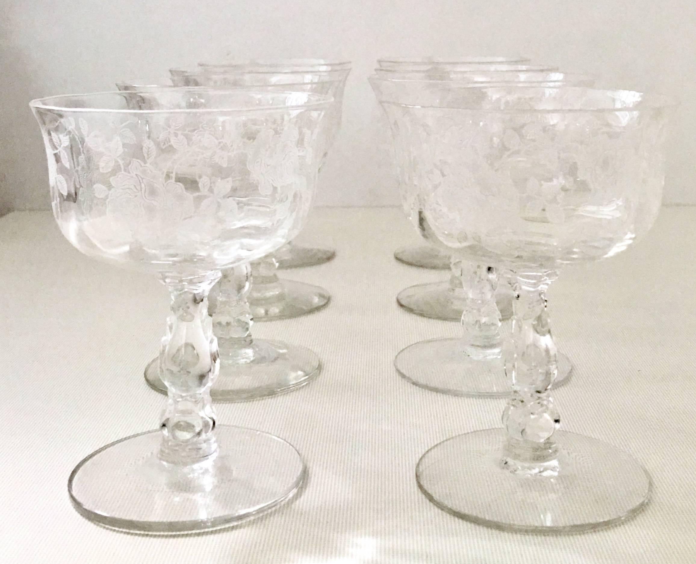 Midcentury American etched cut crystal coupe stem glasses, set of eight. Features a optic shape with a rose and vine pattern.