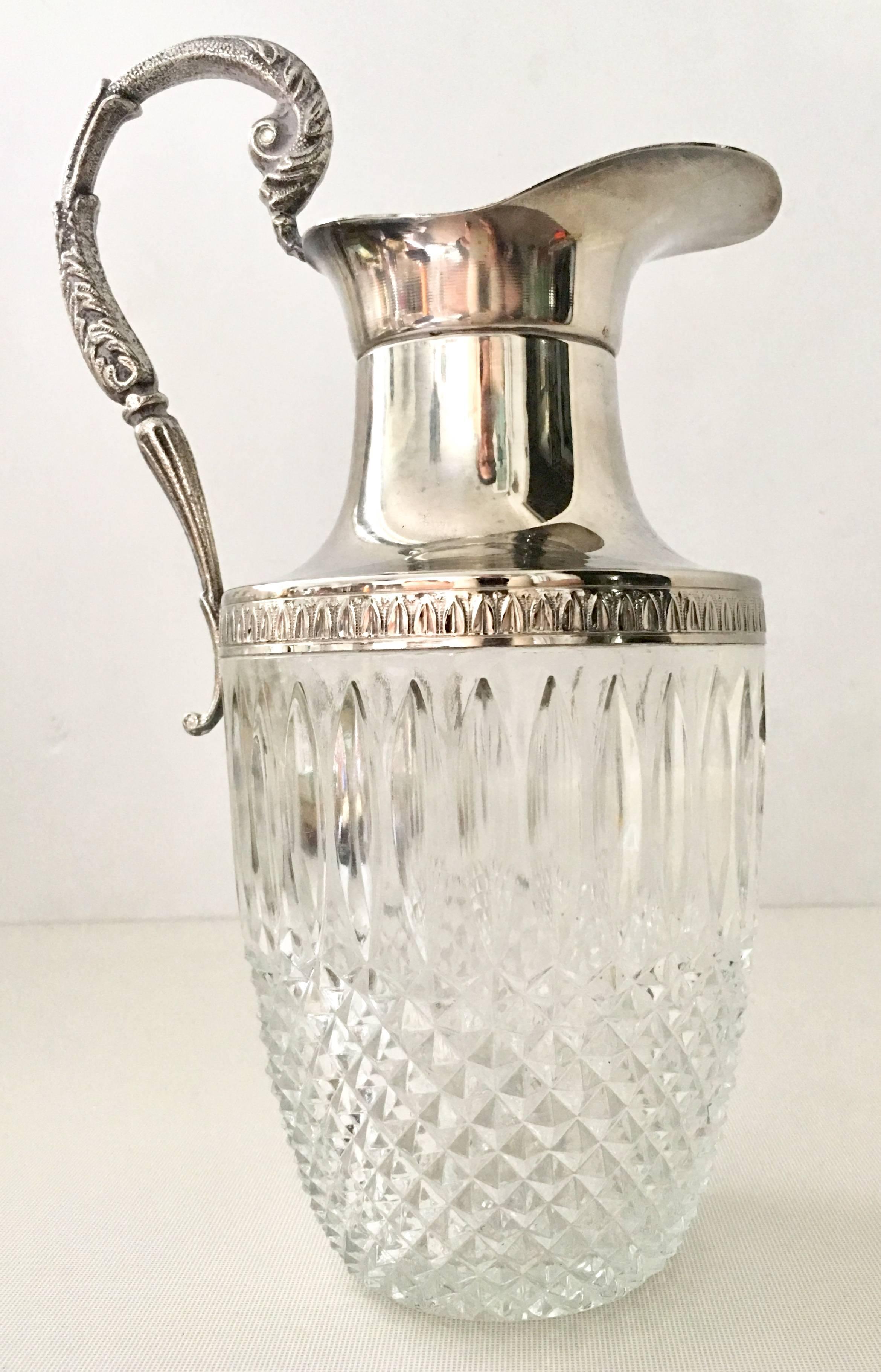 Vintage Georgian style silver plate and cut crystal beverage pitcher. Features a perforated drain at the spout.