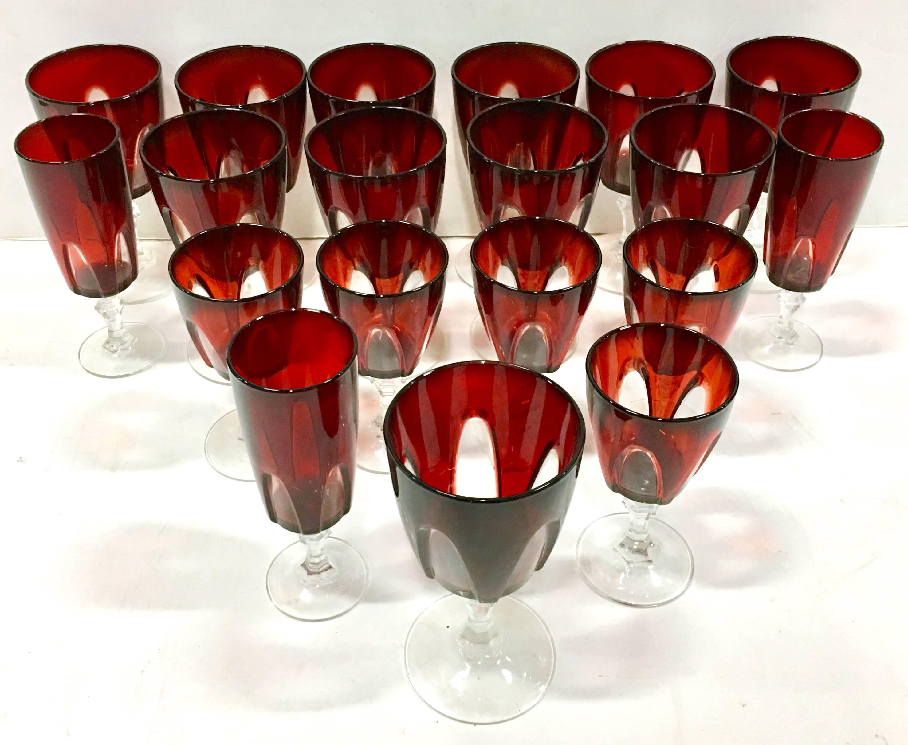 1970s French crystal cut to clear ruby stem glasses, set of 18. This gorgeous and dimensional cut crystal stem features a ruby red gothic raised and cut "window" pattern. Each piece is signed on the underside of the foot, France. This 18