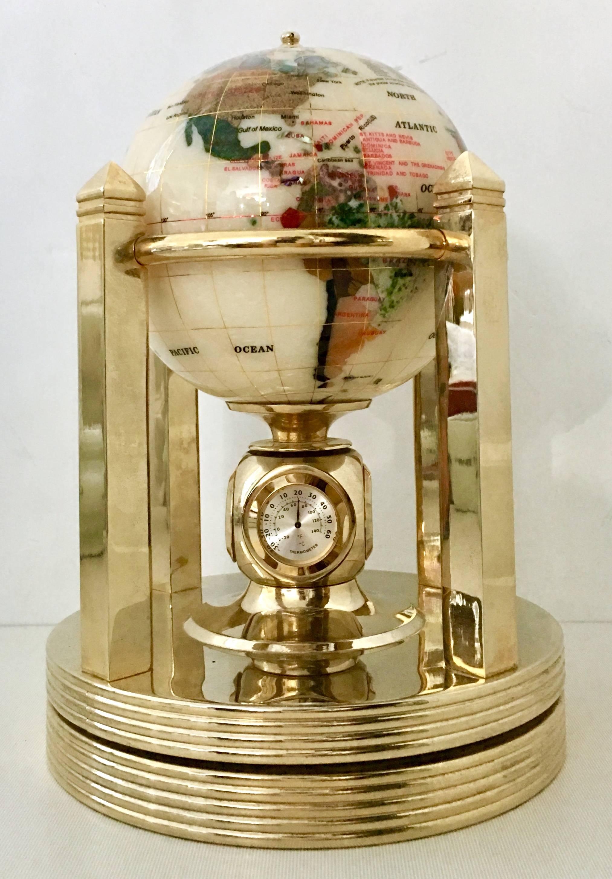 Contemporary mother-of-pearl and semi precious inlaid stone 24-karat gold plated rotating globe on Stand. This 6