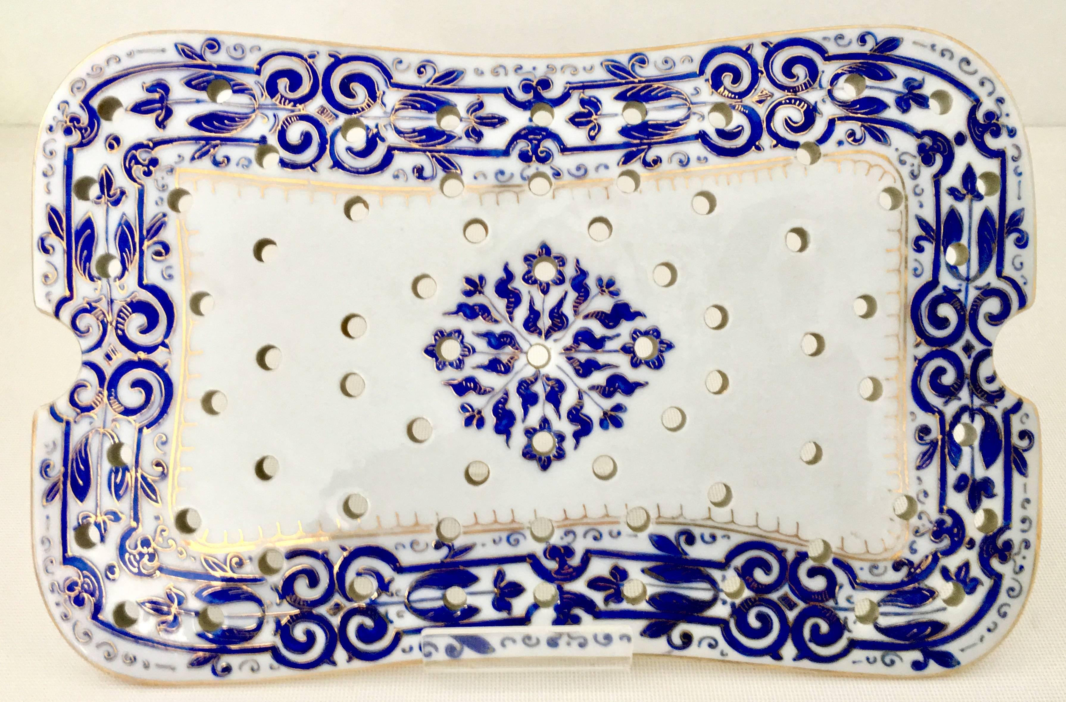 Antique Dresden style hand-painted Porcelain serving tray and trivet by Fischer & Mieg. This extremely rare pattern features a white ground with a vibrant cobalt blue "Persian" medallion floral scroll motif and has raised 22-karat gold