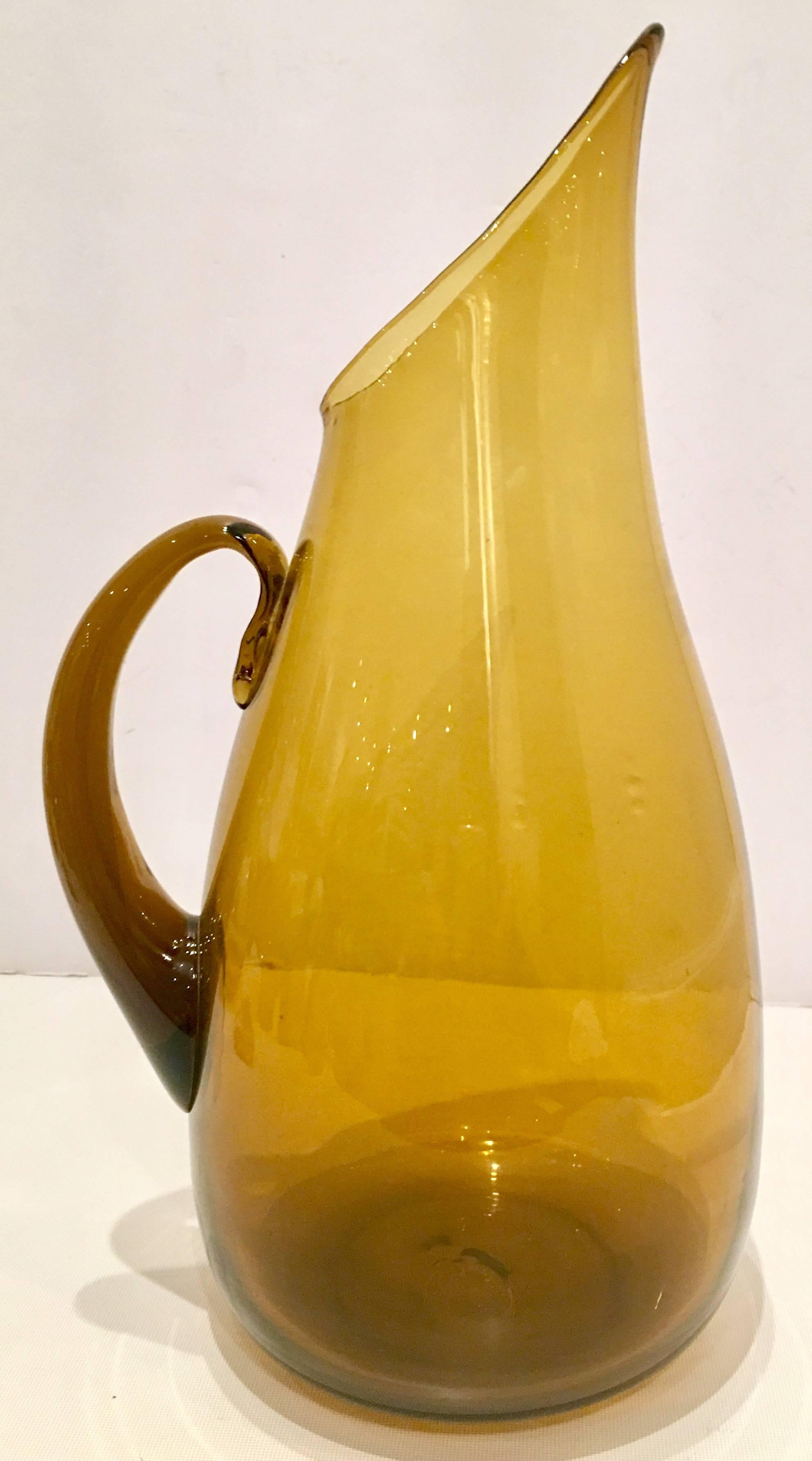 Mid-Century Modern Blenko glass amber applied handle, pointy spout large pitcher. This timeless modern shaped pitcher was designed by in house Blenko glass designer, Winslow Anderson during, 1947-1953.