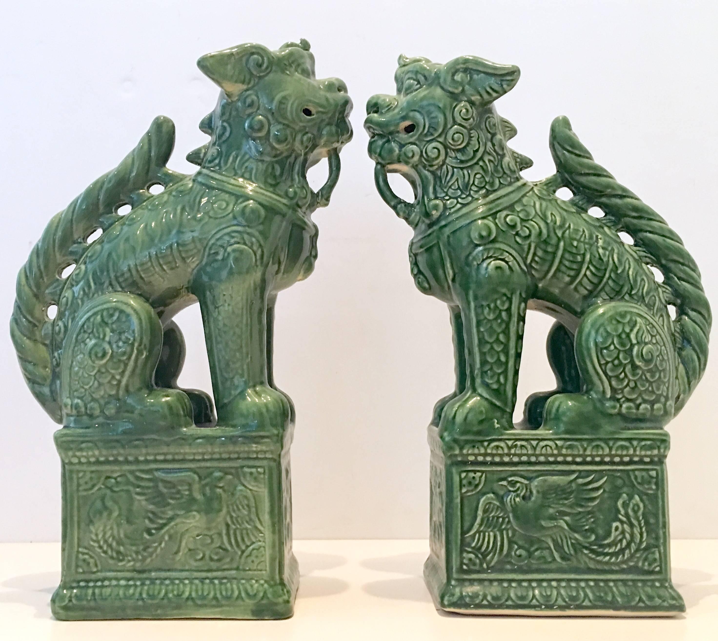Pair of 21st century ceramic glaze large foo dog-guardian lion sculptures. Finished in green with excellent attention to detail.
