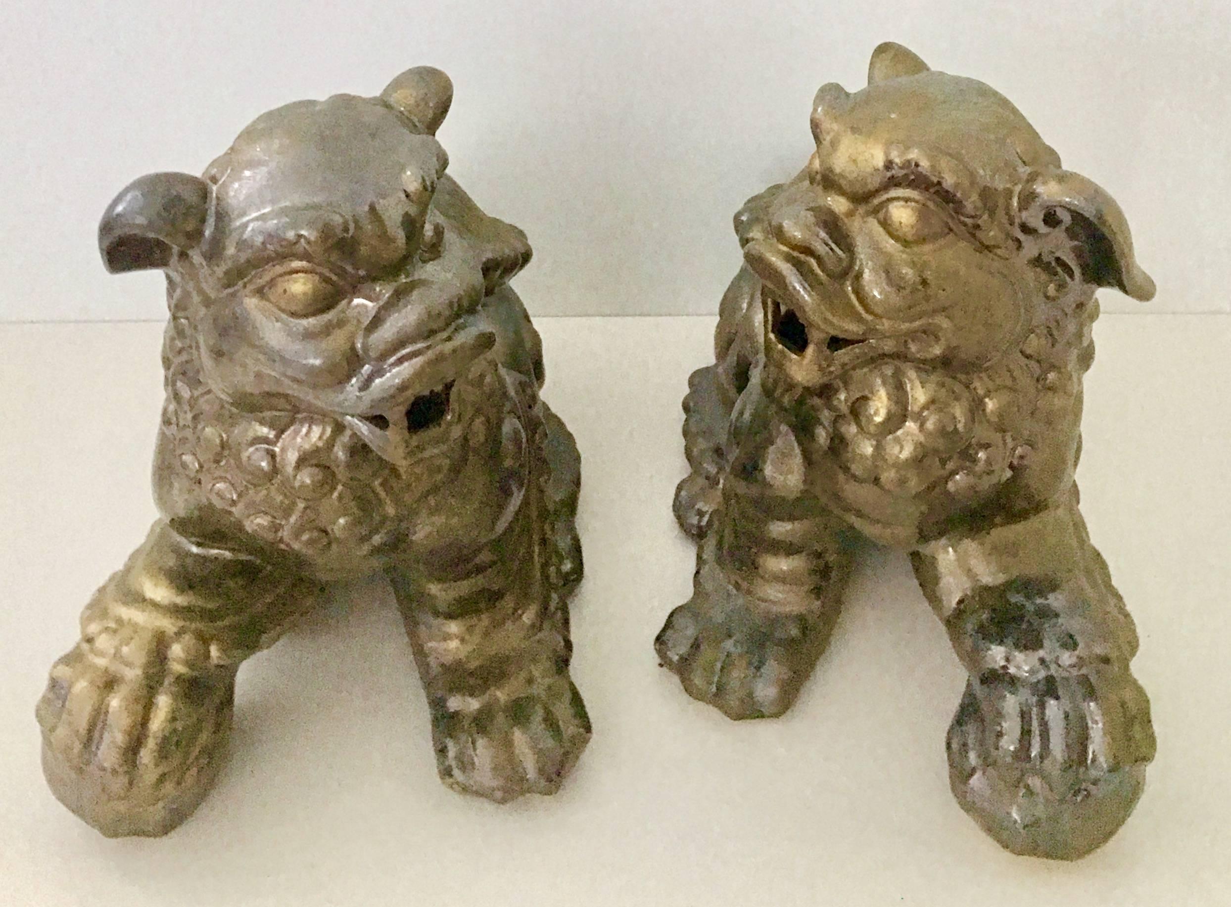 Contemporary pair of ceramic glaze foo dog sculptures. This large pair of foo dogs, have a metallic burnished gold gloss finish.