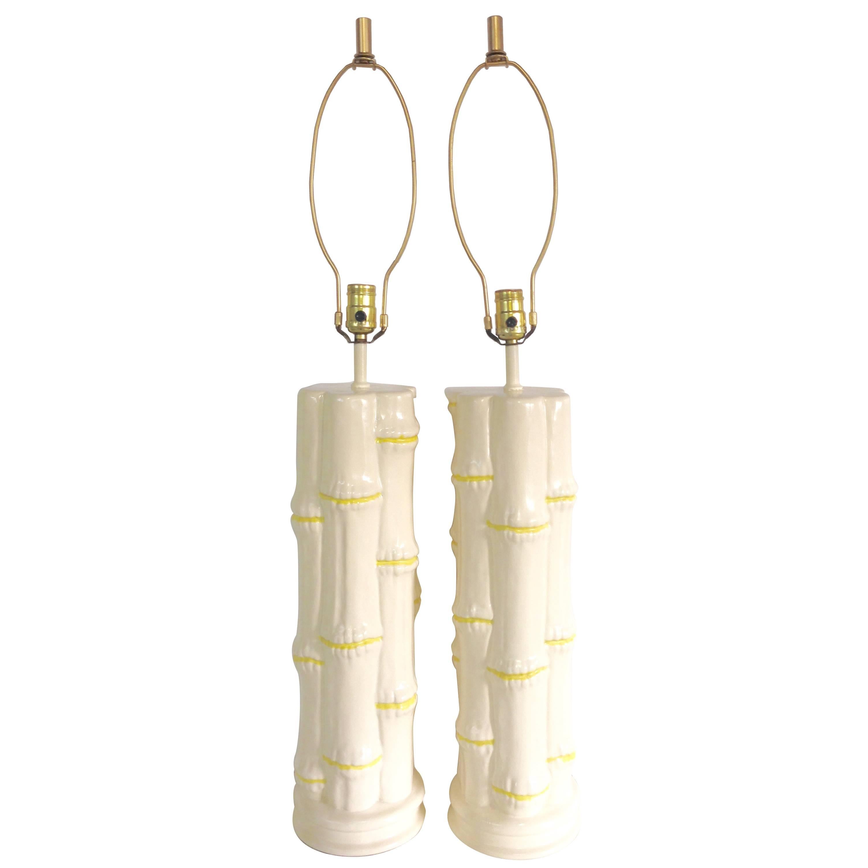 1960'S Pair Of Hollywood Regency tall ceramic glaze white and yellow faux bamboo table lamps. Features original brass fittings. Includes pair of brass finial and harps. Wired for the US and in working order. Takes a standard light bulb, max watts