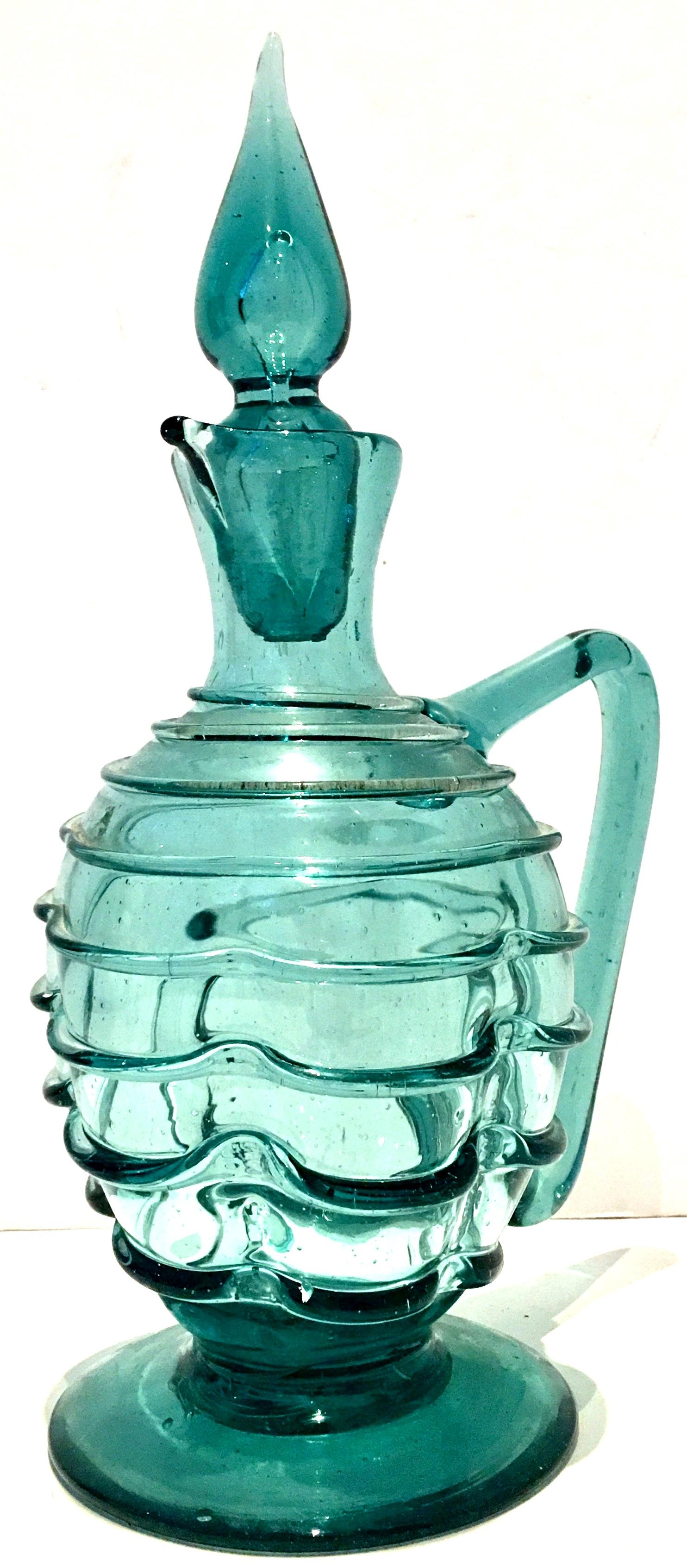 1950s American modern blown glass teal ribbed and footed decanter with genie style stopper.