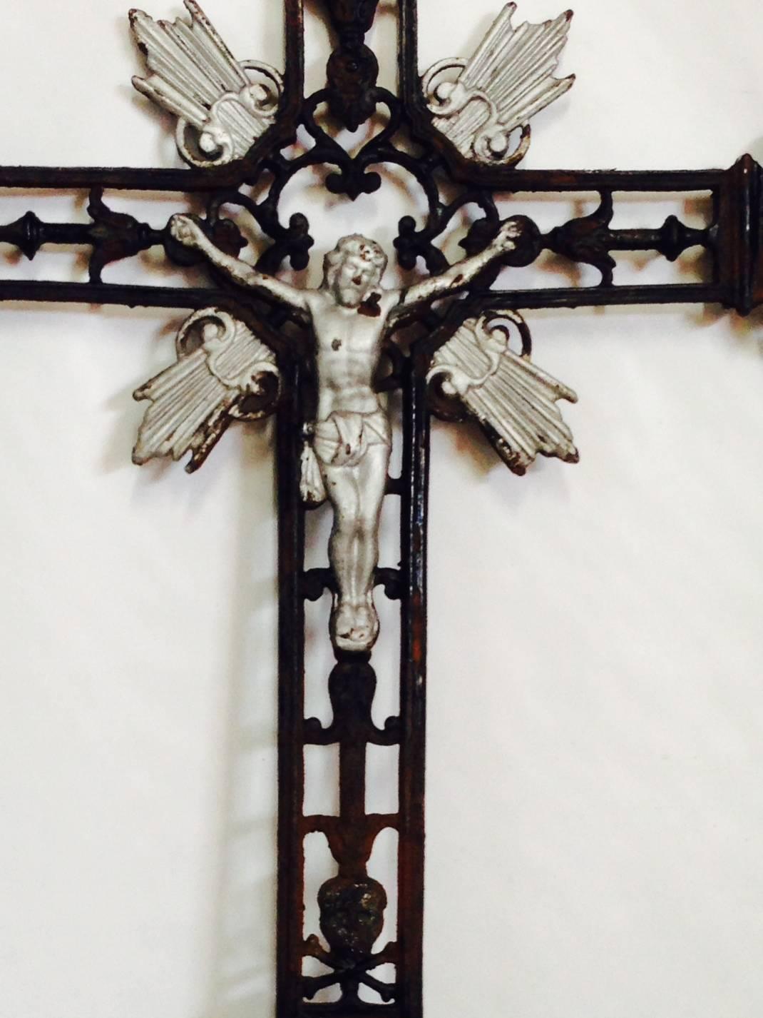 Early 20th Century 5" foot tall heavy painted cast iron crucifix grave marker. Silver leaf detail. Art Deco in style with figural Jesus and skull & cross bone detail.