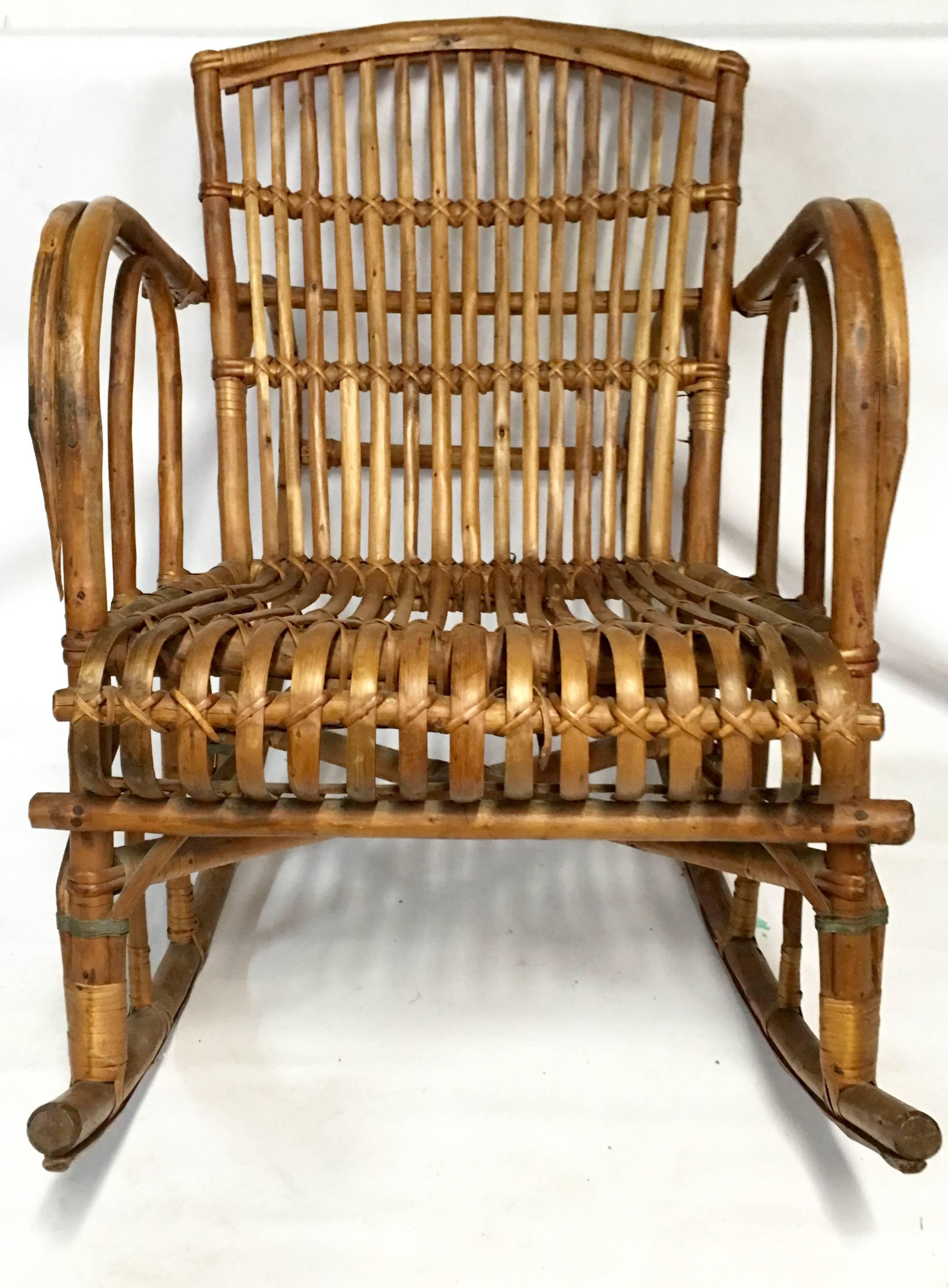 Mid-Century Bent Rattan Franco Albini style low profile rattan rocking chair.

