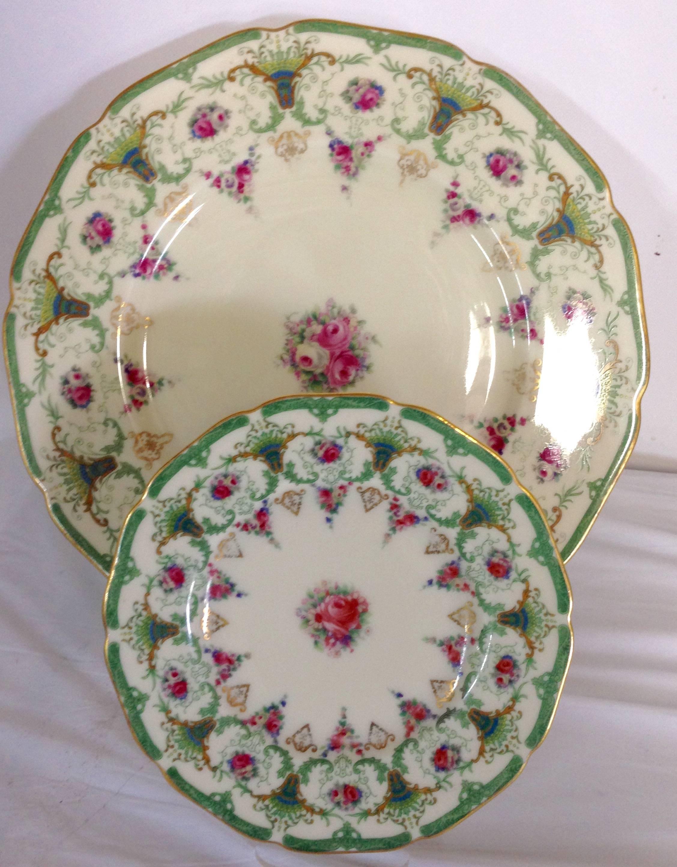 Rare 17-piece green and pink scalloped porcelain plate set by Black Knight.. Set includes: Nine bread plates, 6.25