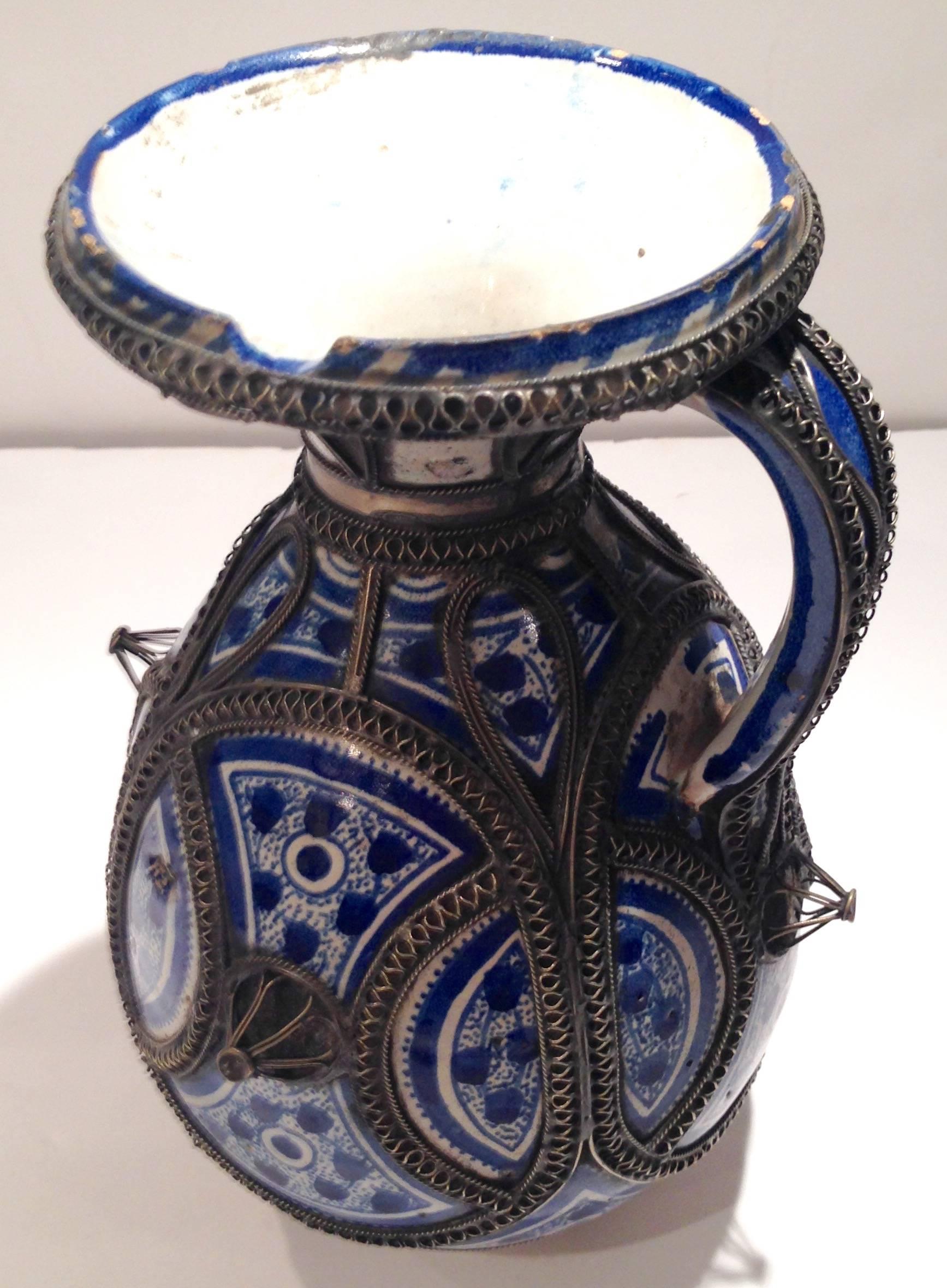 Rare handmade pottery handled pitcher from Fez, Morocco. Decorated in blue and white (Bleu-de-Fez), designs enhanced further with a very ornate example of the technique called 