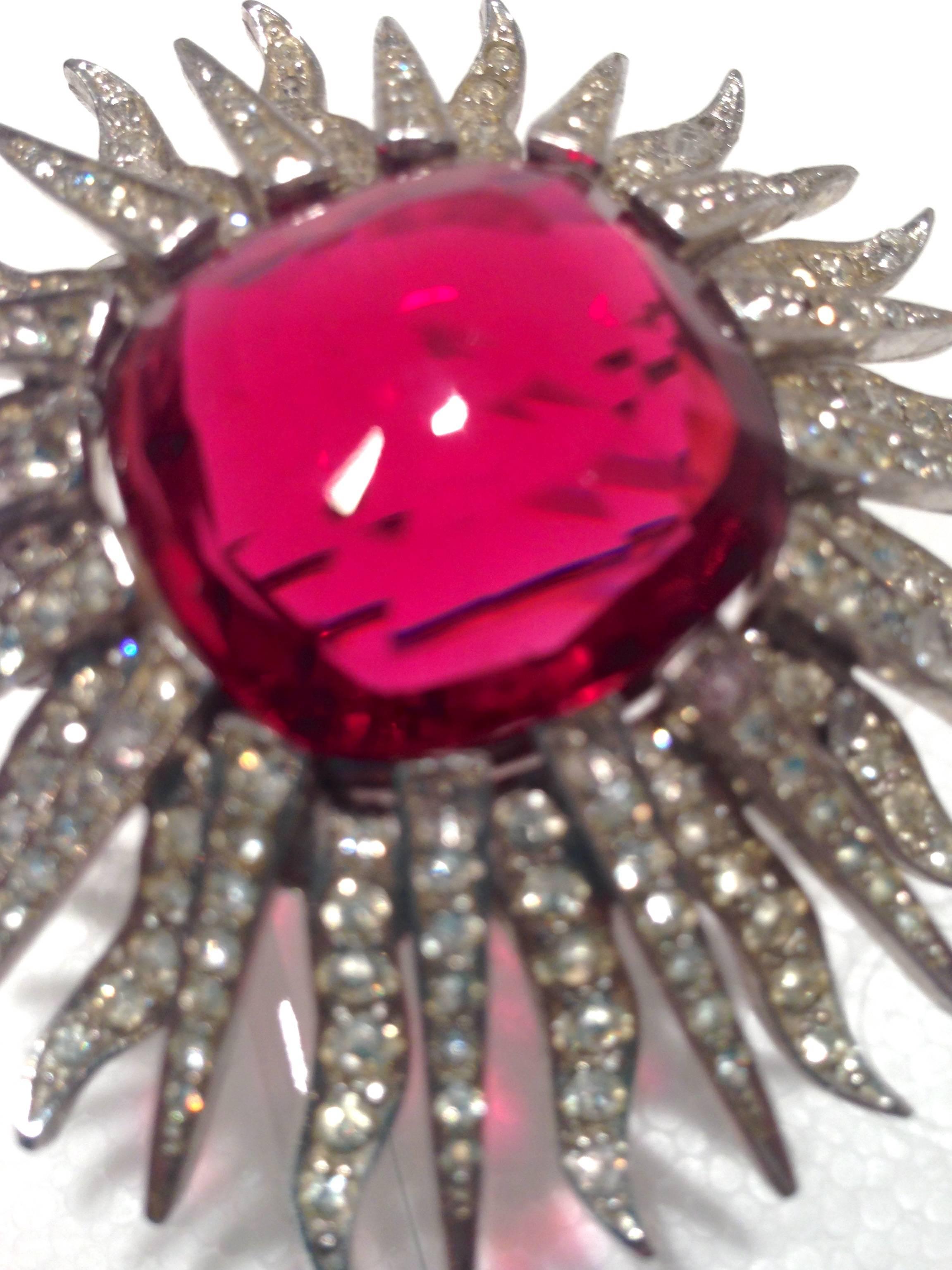 Fabulous Marcel Boucher brooch in excellent condition with no missing stones. Signed Boucher and numbered 7923P. The multi-faceted ruby red center rhinestone is surrounded by 32 