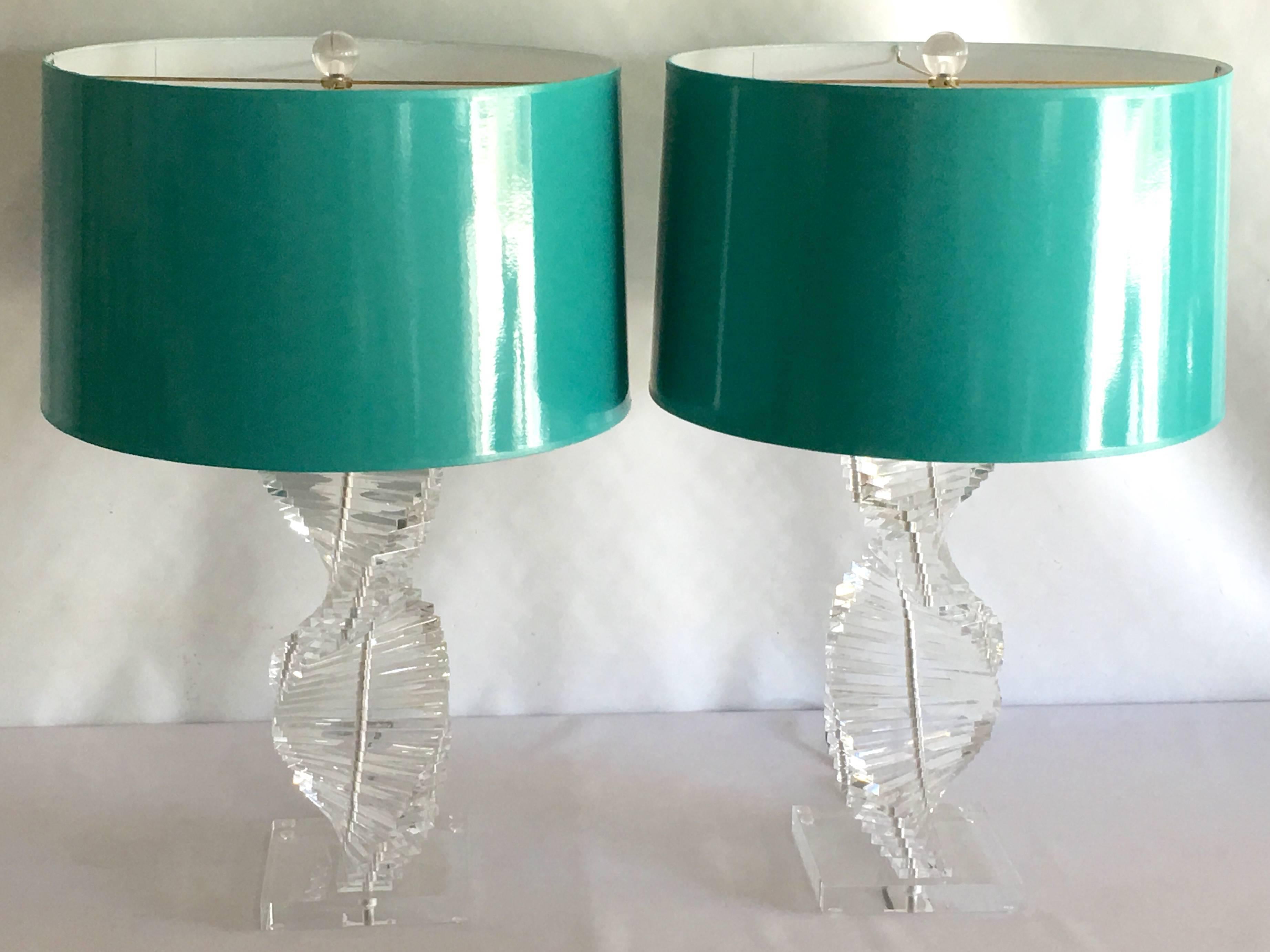 A rare pair of Karl Springer, style spiral Lucite lamps. Heavy duty and carved to the highest standards of craftsmanship. These lamps are quintessential 