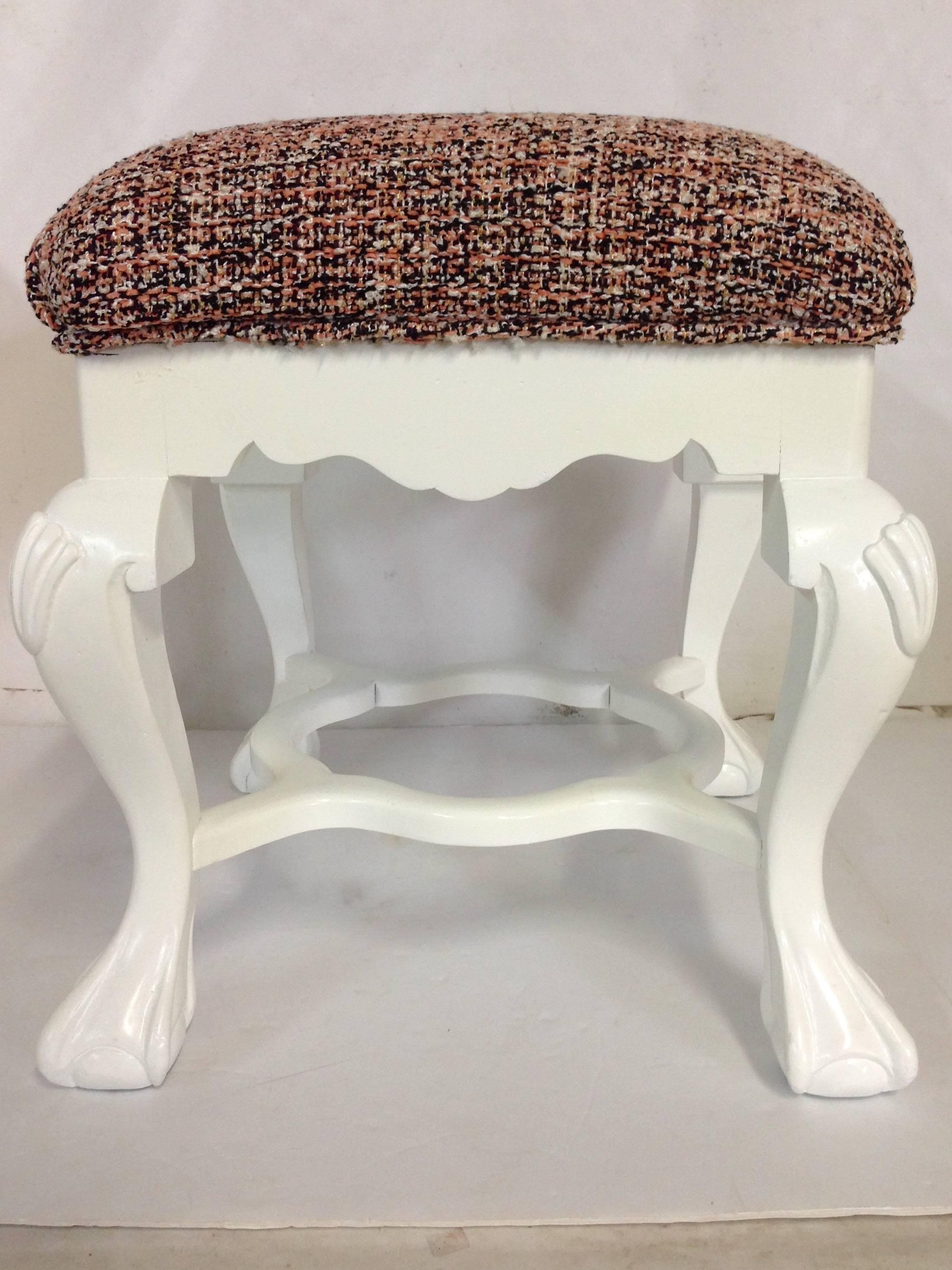 Large carved mahogany wood ottoman/bench, re-upholstered in Chanel - style
wool blend bouclé vintage fabric. Fabric is pink, black, white and has some metallic threading throughout. Fabric is in excellent vintage condition.