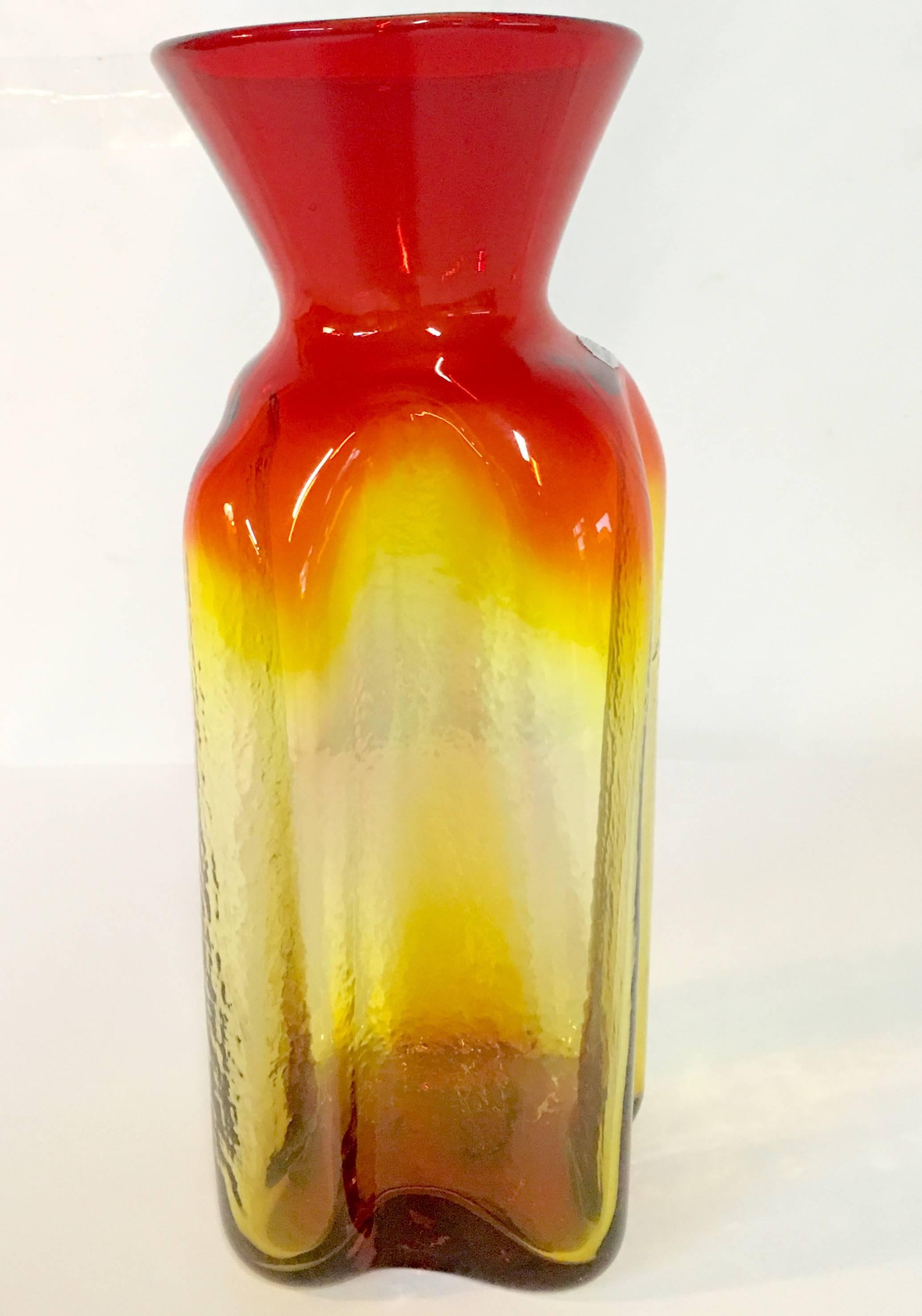 Large Blenko handblown glass tangerine four sided indent vase. Designed by, Wayne Husted, between 1952-1963. Silver "Blenko Handcrafted" sticker still intact. Pontil makers mark on the underside.