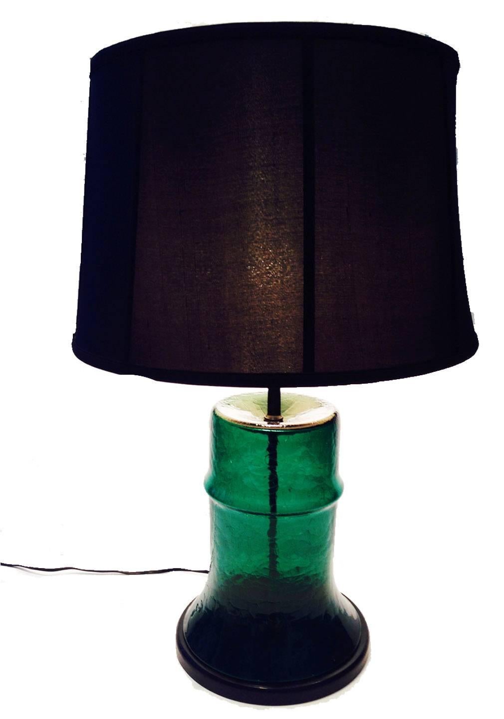 Rare Blenko Glass Co. emerald green handblown barrel shaped lamp. Original brass fittings, black wood base. Shade not included. Wired for the US and in working order.
