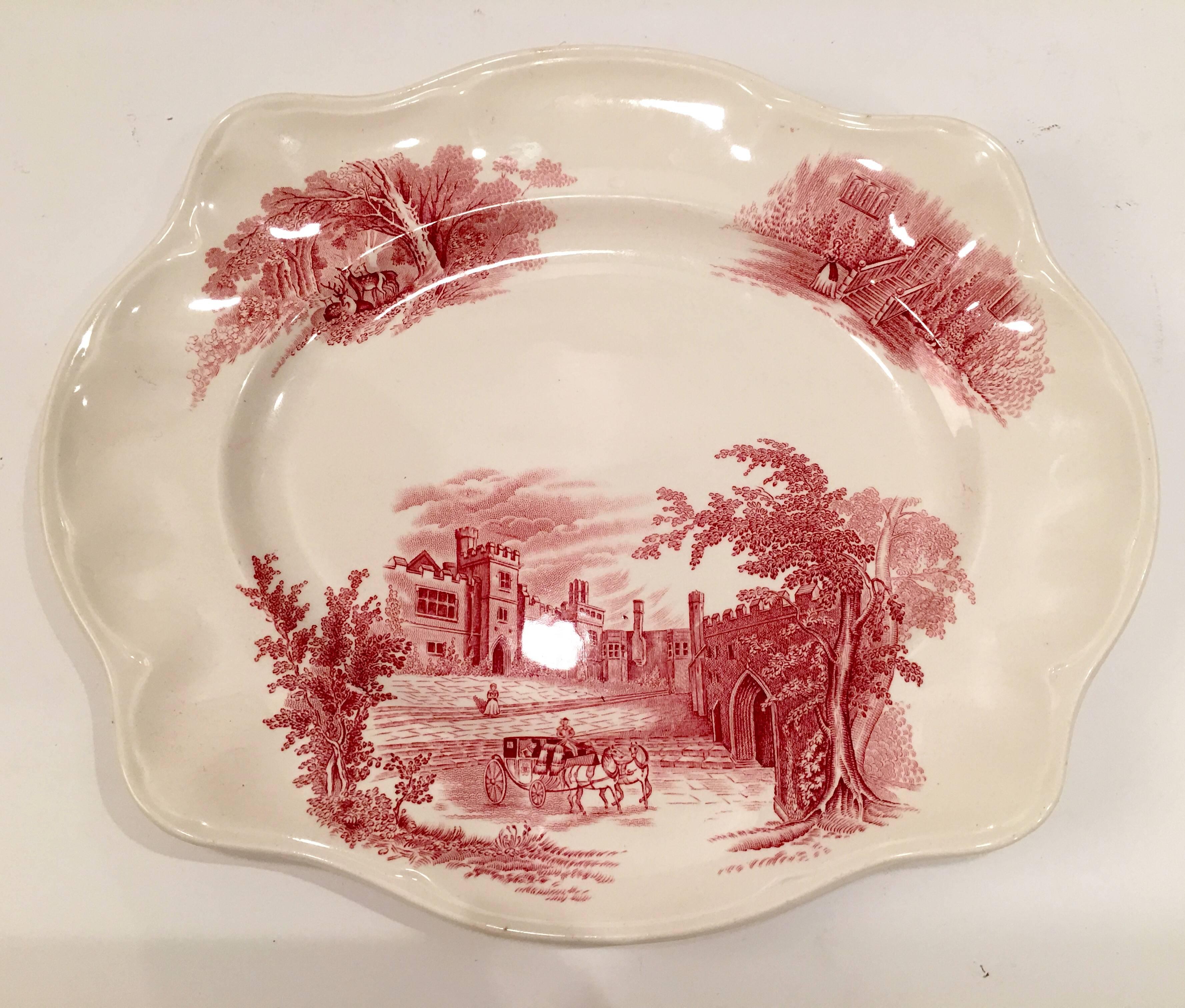 Rare English ceramic dinnerware collection of seventeen pieces "Haddon Hall" Pink. "Haddon Hall" is renowned as the scene of elopement of Dorothy Vernon in 16th Century".The pattern depicts a horse drawn carriage in front of