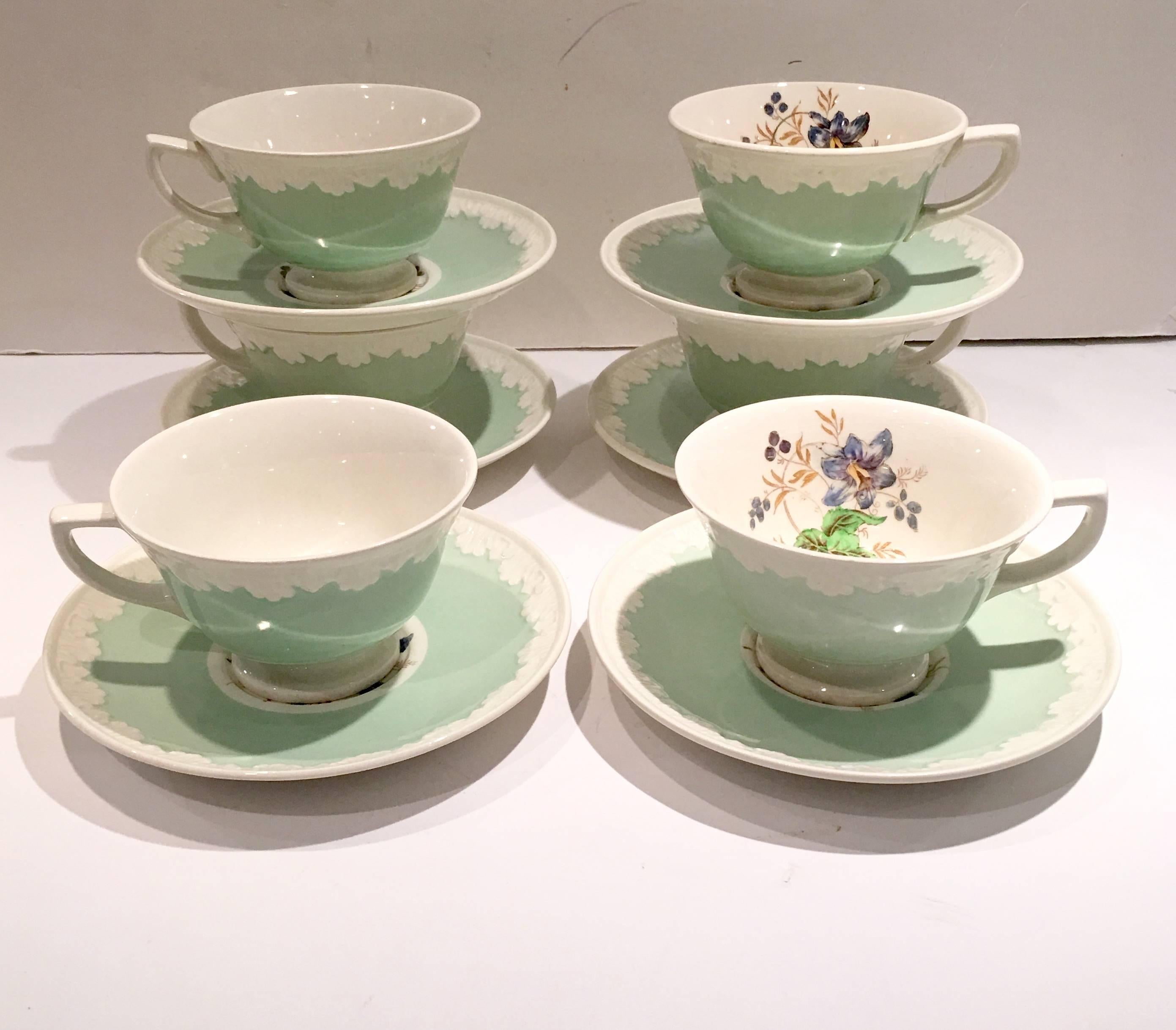 1930'S Wedgwood England, "Hampton Court Corinthian" pattern in mint, cup and saucer set. Set includes, six saucers and six tea/coffee cups. Tea cups measure, 2.5: height x 5" length x 4" diameter. Signed on underside.