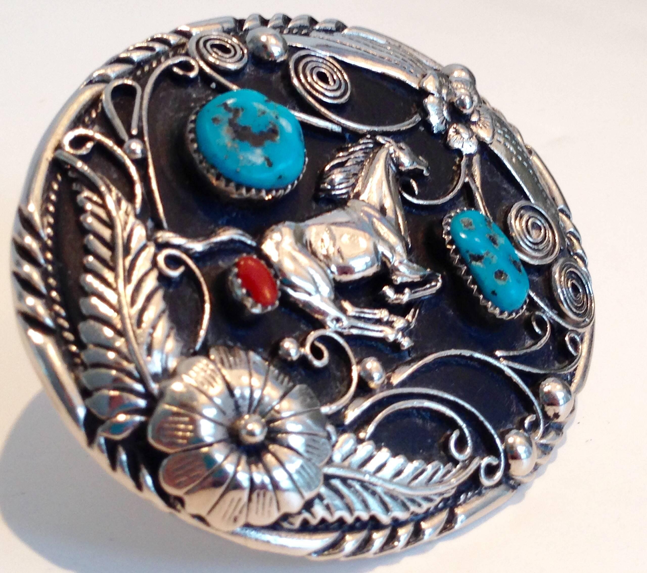 Finely-detailed, handcrafted authentic vintage Navajo belt buckle. Carved silver feather detail with a central mustang. Back finished in silver plate. Signed on underside by Navajo artist, S.S.I and hallmarked. Each genuine turquoise stone measures