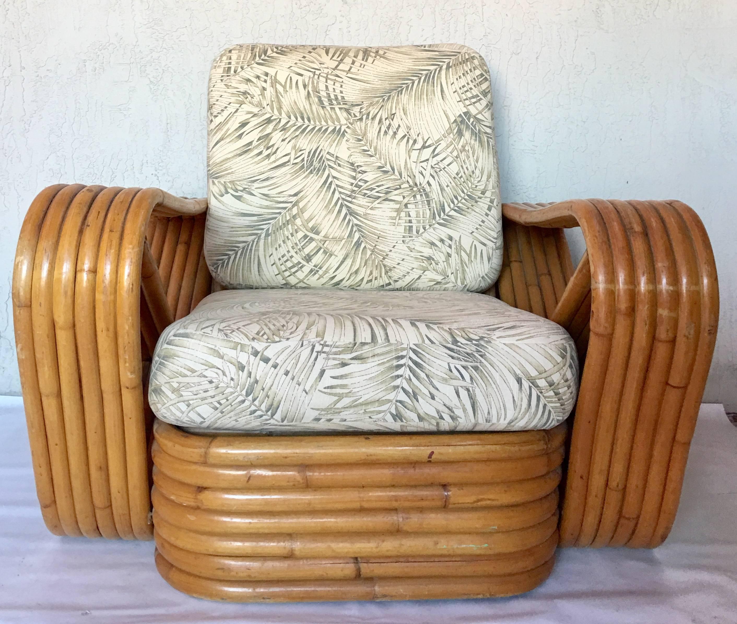 1940s Paul Frankl designed rattan reed six-stack square "Pretzel" style armchair and seven reed stack base ottoman. Ottoman measures, 21.5" square and 9" inches in height.
Includes two original fern motif zipper slip covered