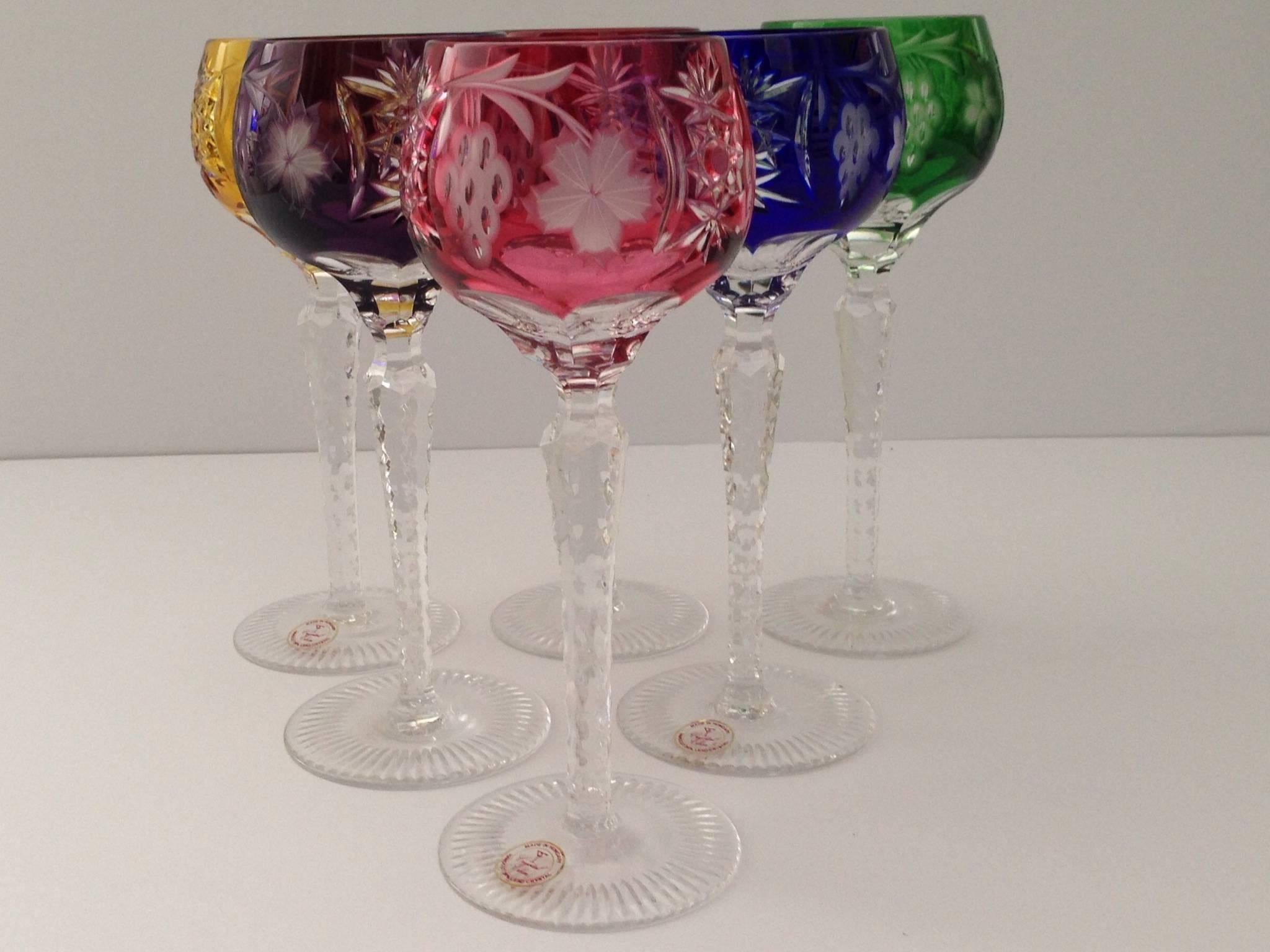 Vibrant set of five cut crystal Bohemia glass hock wine stem goblets. Set includes one of each color, amethyst, green, yellow, cobalt and ruby in a starburst and grapevine pattern.
