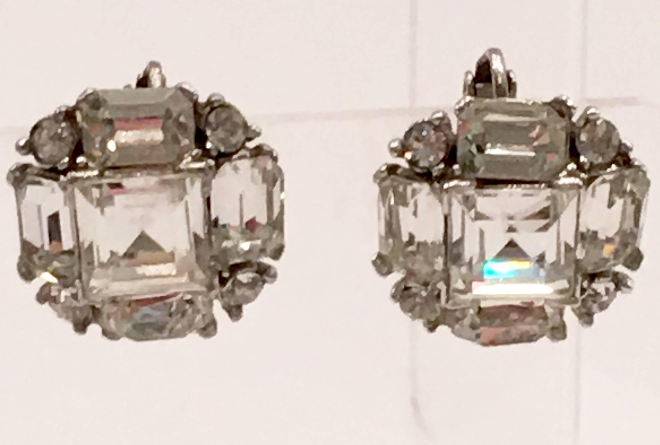 A special and amazingly brilliant pair of Austrian crystal clear emerald cut large clip back and screw back earrings set in sterling silver by, Bogoff. Set in silver plate and signed, Bogoff on the underside.