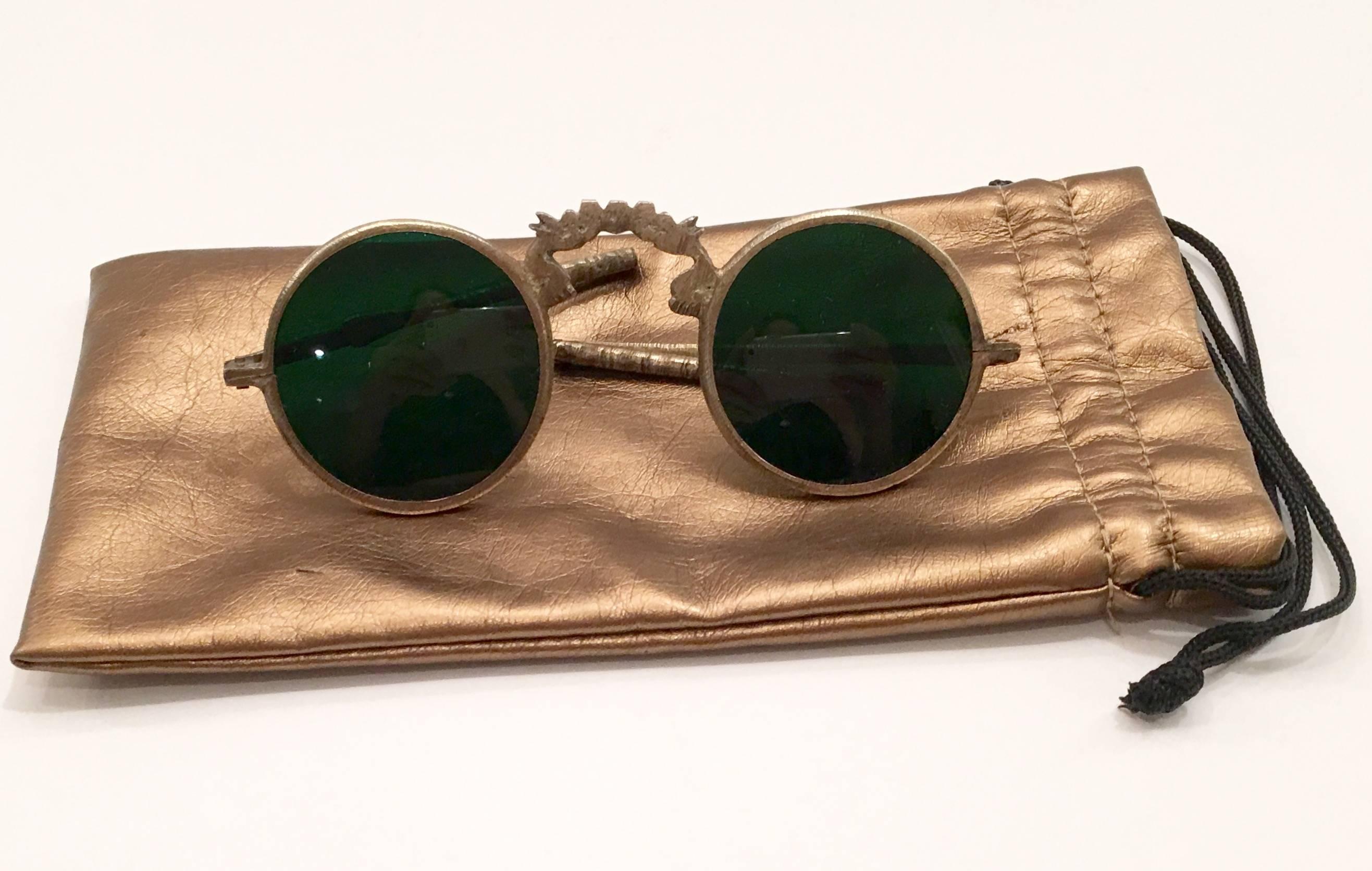 Rare 1800s antique Chinese folding sunglasses made of brass with a small part of silver nickel. Green glass lens color and dragon motif at bridge. Includes a gold metallic soft protective storage case.