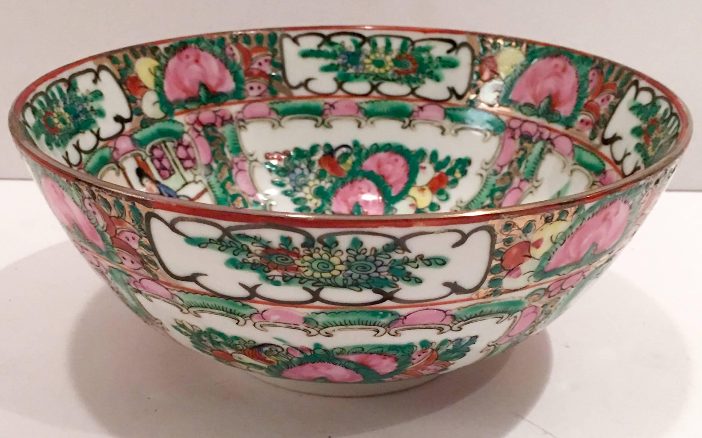 Qianlong, Da Qing dynasty style hand painted famille bowl. The pattern depicts a paneled courting couple in a garden with 22K, gold rim detail and signed on the underside with a four character red chop mark.