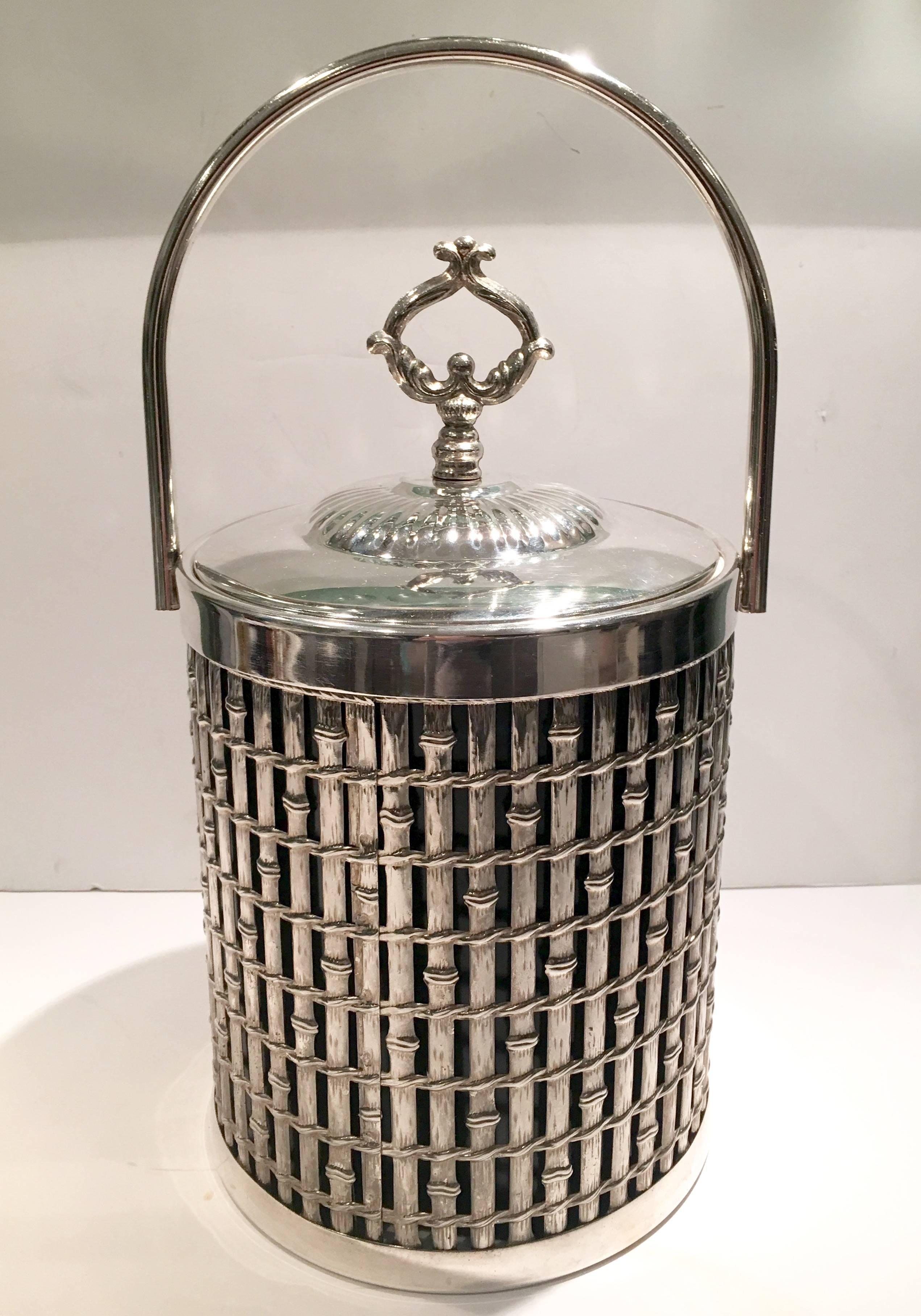 Fantastic Hollywood Regency faux bamboo lattice silver plate tubular handle and lidded ice bucket. White thermal liner. Bucket with out handle and lid height,
10.25" inches.