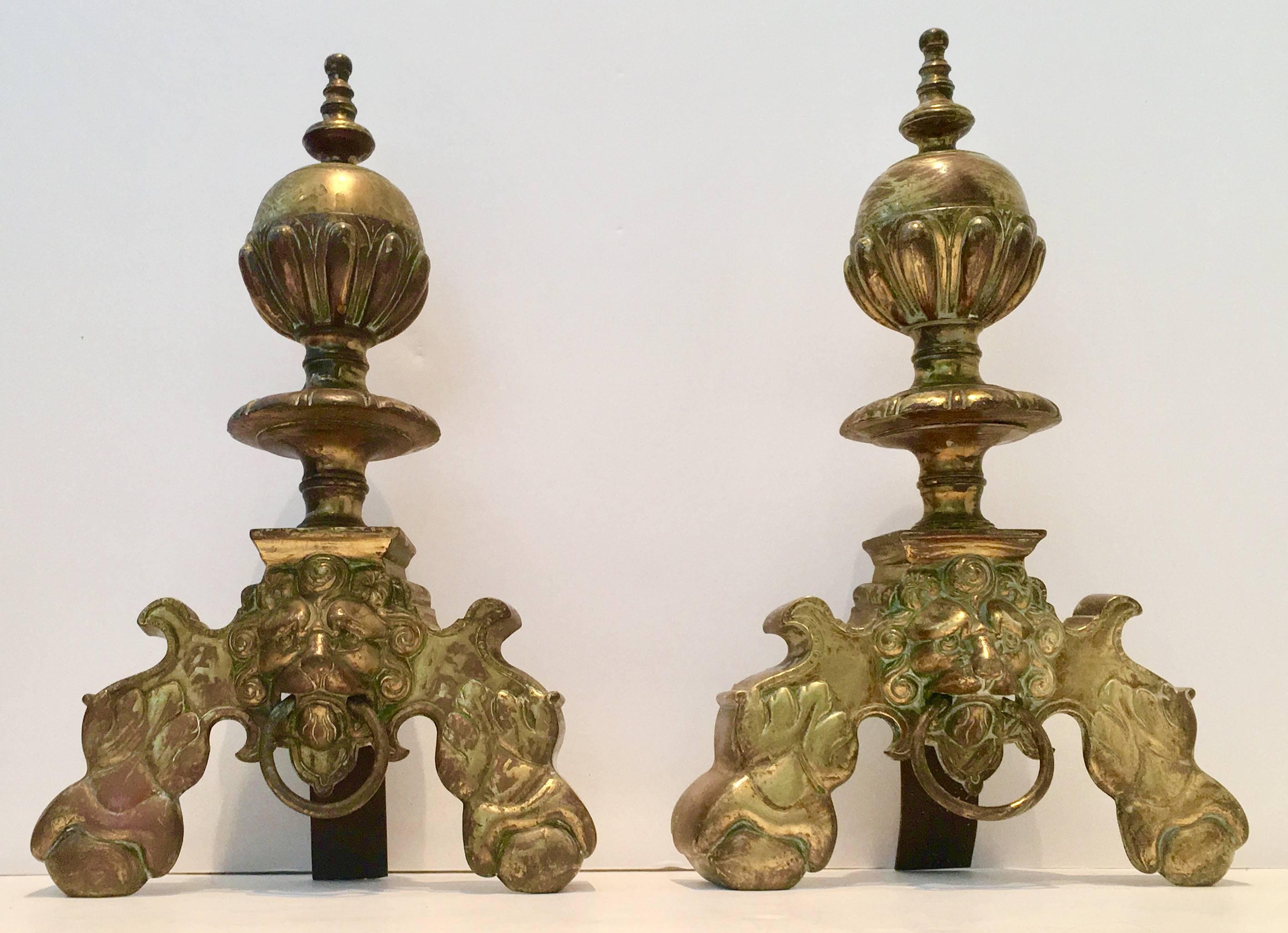 Great pair of lion and ball door knocker solid brass andirons. This pair of very rare chenet/andirons have a faux verdigris wash applied to them. Door knocker ring is adjustable.