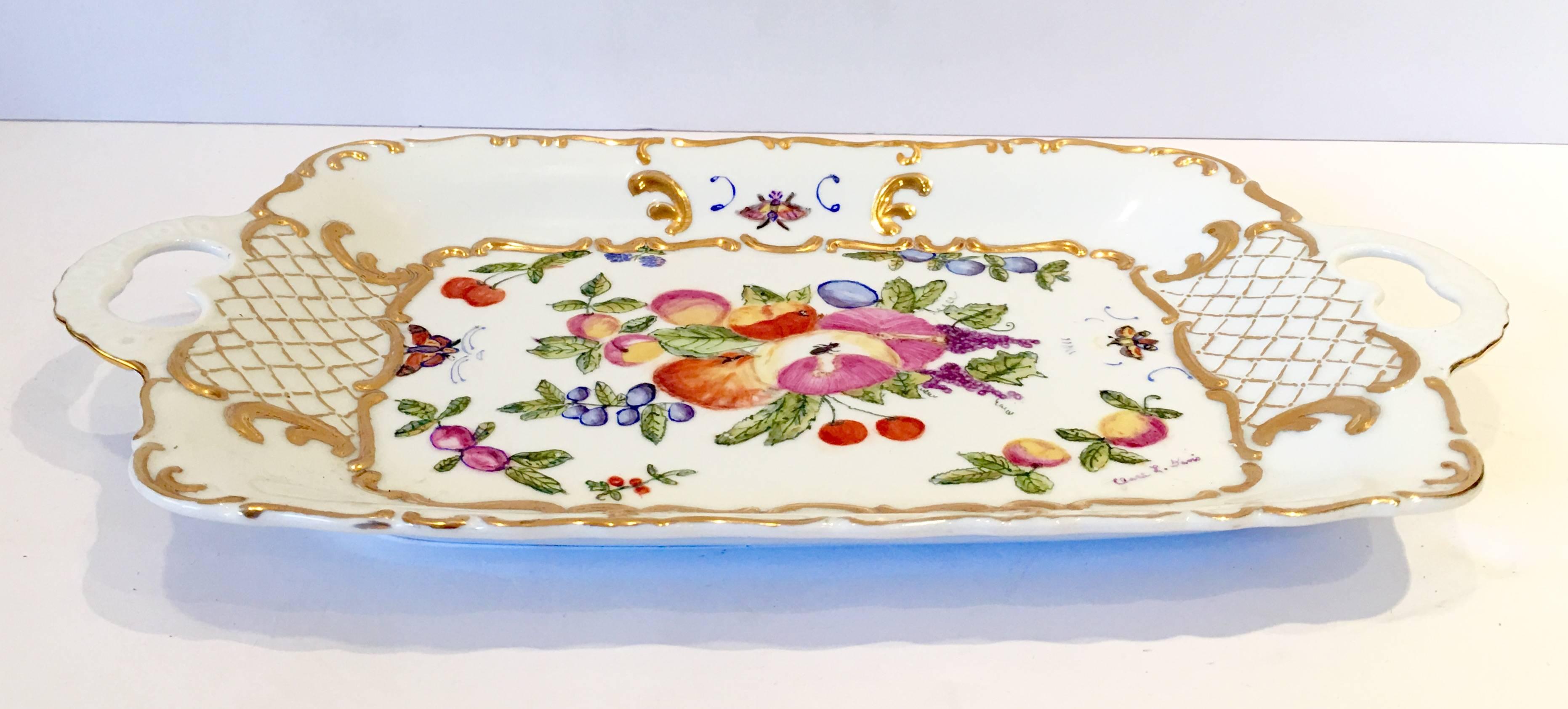 Bavaria West Germany bright white hand-painted with 22-karat raised gold lattice detail fruit and butterfly motif two handles rectangular tray/paltter. Artist signed lower right as manufacturers mark on the underside, Gerold Porzellan Bavaria West