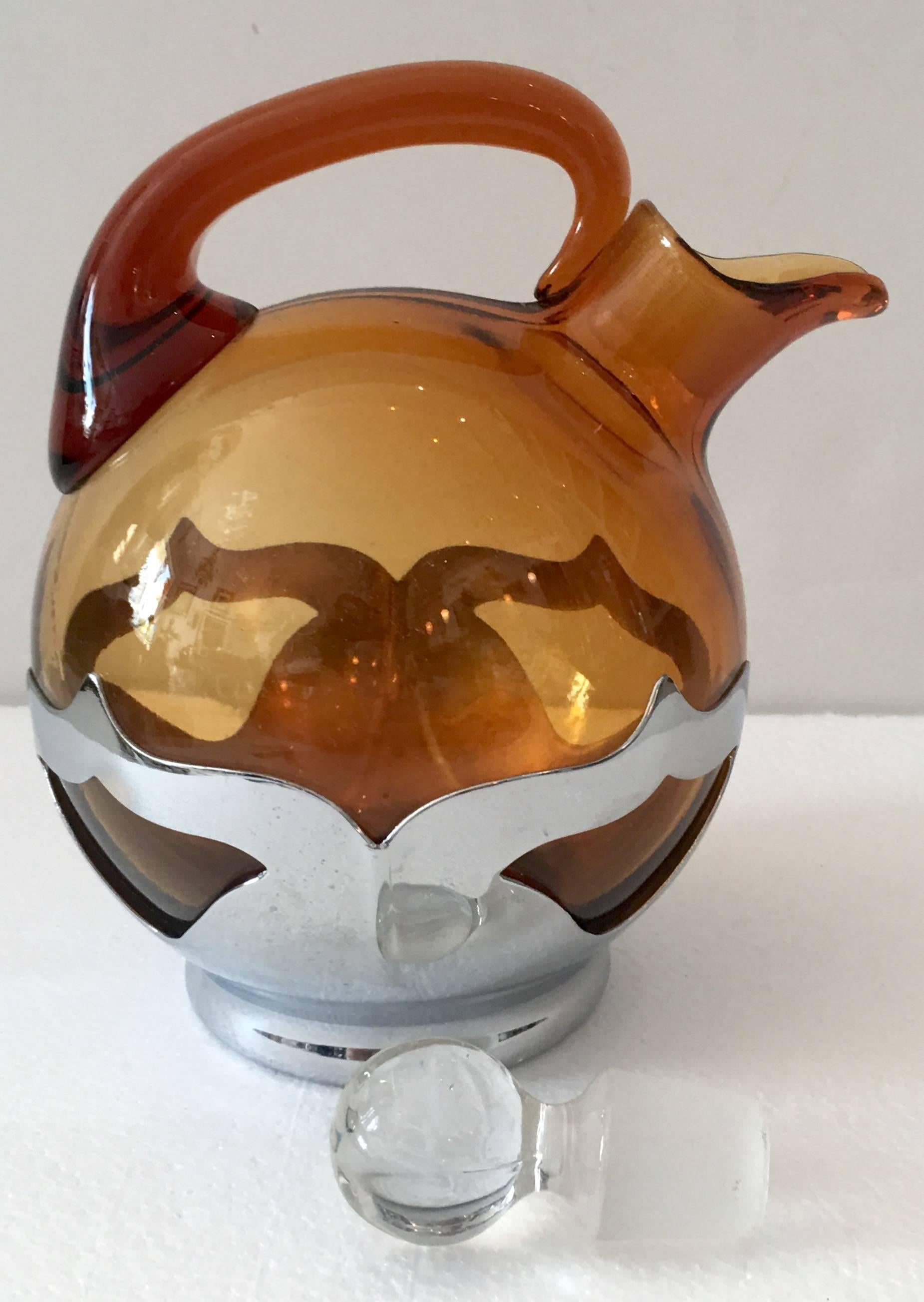 Rare Cambridge Art Deco style amber glass decanter set of eight with Farber Brothers (est. 1915) non-tarnishing Krome-Kraft holders. Set includes one teapot style decanter with glass stopper and six cups. Each piece is signed on the underside,