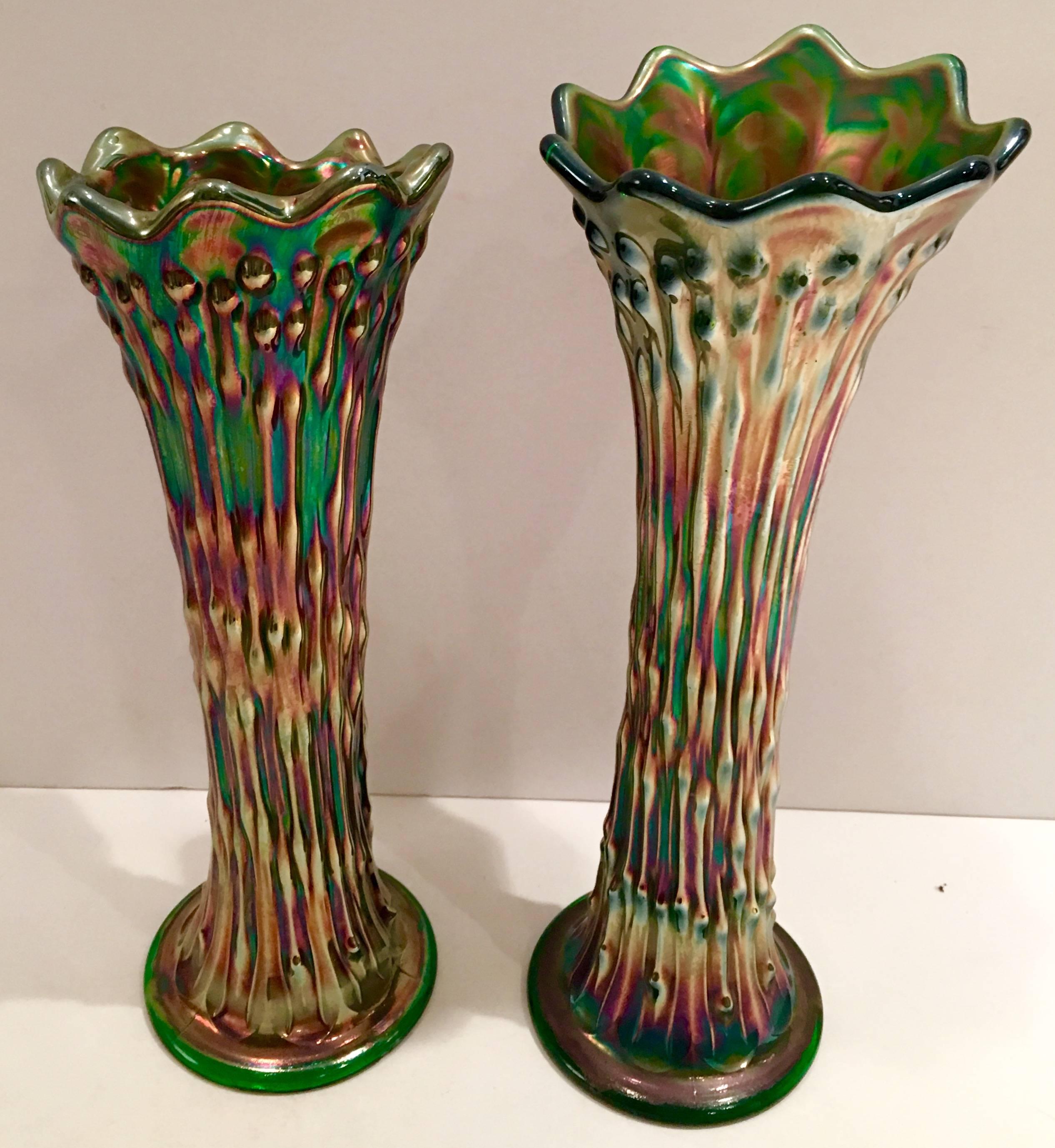 Beautiful pair of  Antique Fenton art glass emerald green iridescent vases. Each has the same makers mark on the underside. The smaller vase measures 10.5" height x 3.5" diameter.