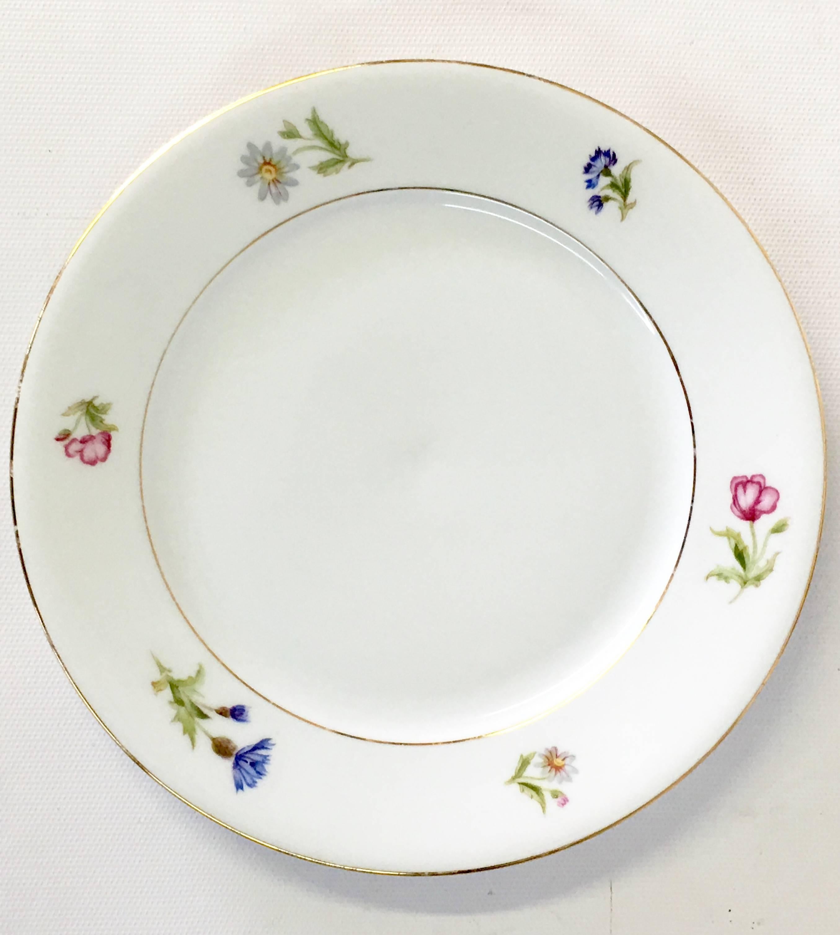 Vintage Meissen style Bavaria Germany white ground with scattered floral edge and 22K gold rim hand painted porcelain dinnerware. This 39-piece set includes, ten salad/dessert plates, eight soup/cereal coupe bowls, ten bread/butter plates and eleven